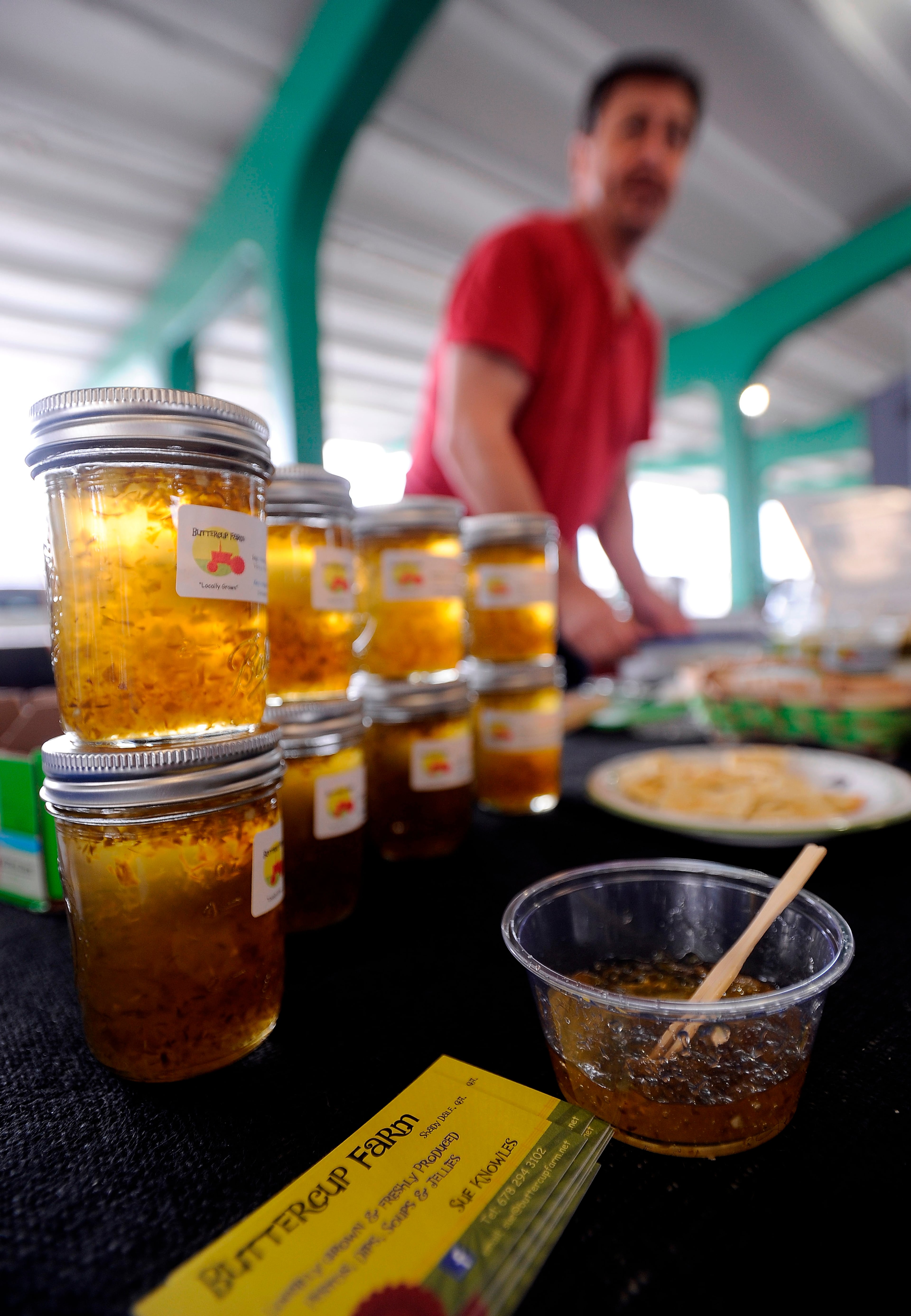 Martin Knowles displays fresh jellies from his wife's Buttercup Farm in Shady Dale, Ga.