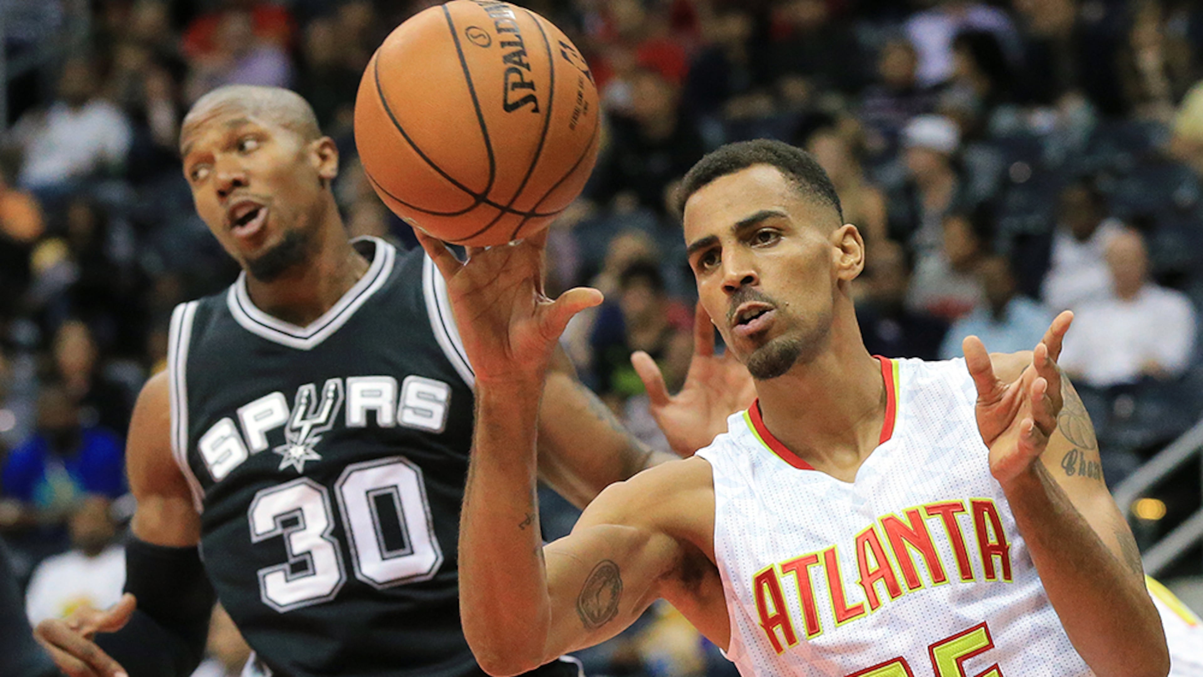 Hawks forwardThabo Sefolosha, playing in a game for the first time since being injured outside a Manhattan night club last season, rebounds against Spurs forward David West in their preseason matchup Wednesday, Oct. 14, 2015, in Atlanta.