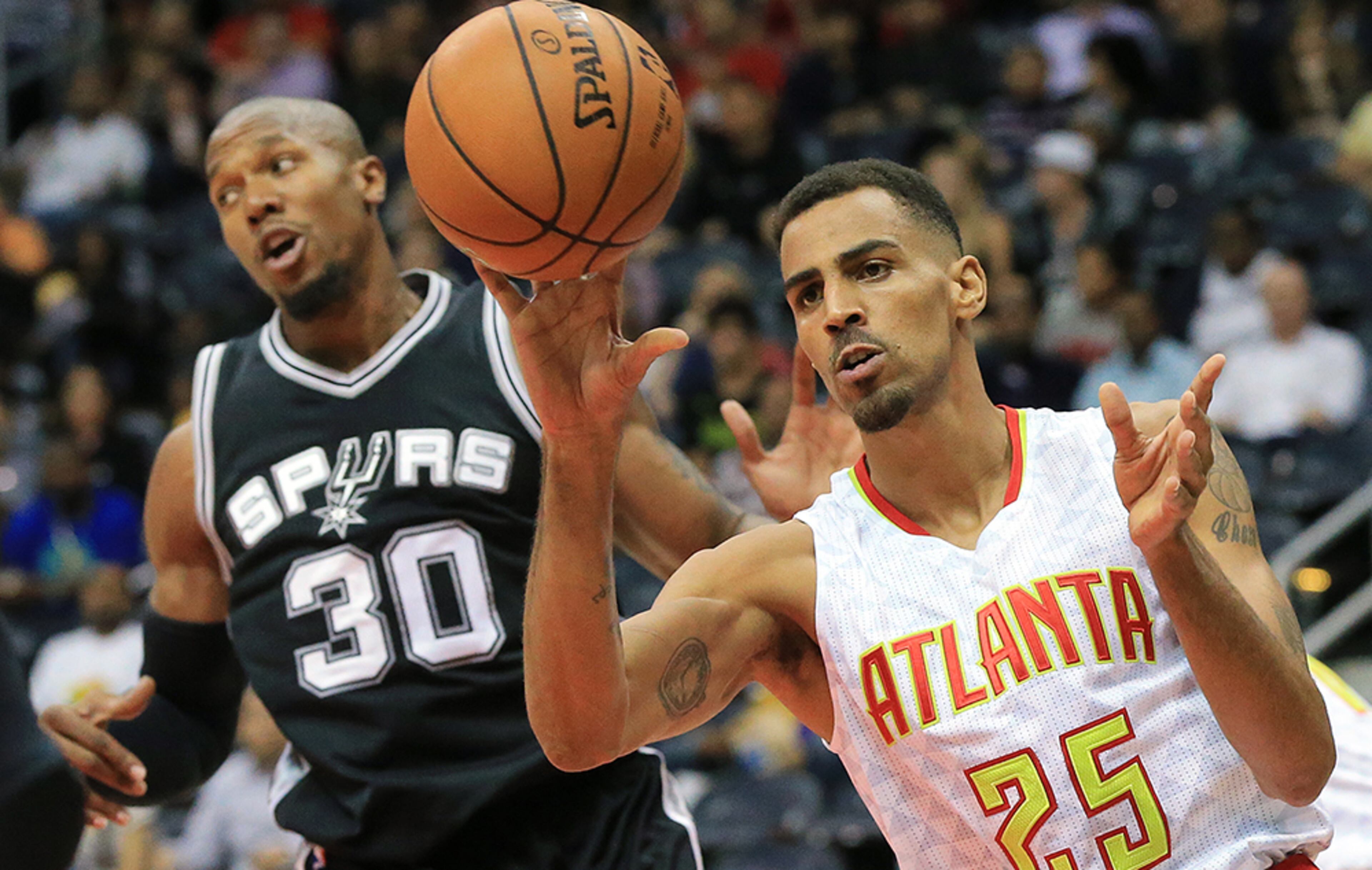 Hawks forwardThabo Sefolosha, playing in a game for the first time since being injured outside a Manhattan night club last season, rebounds against Spurs forward David West in their preseason matchup Wednesday, Oct. 14, 2015, in Atlanta.