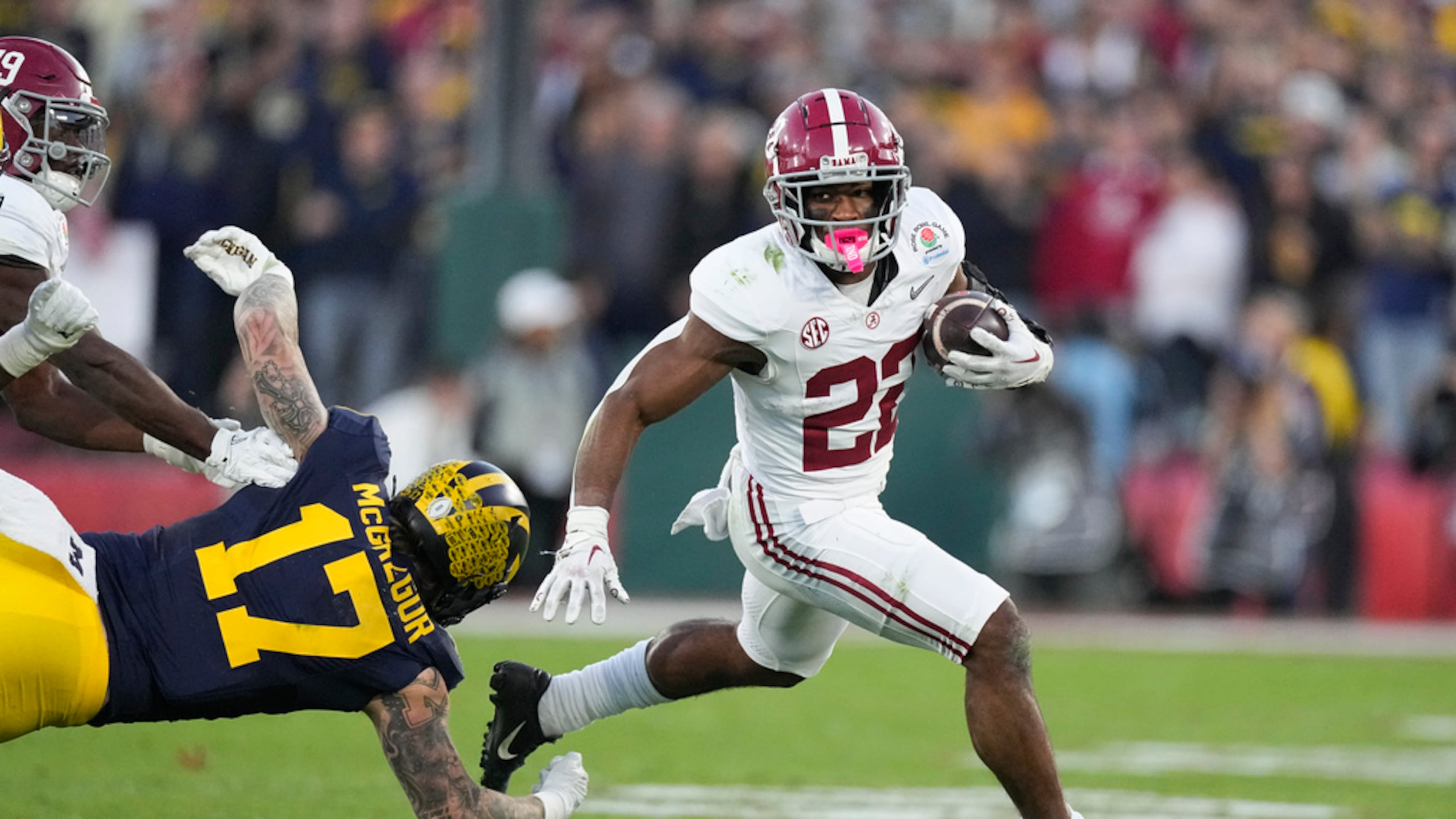 Running back Justice Haynes (center) — pictured playing for Alabama in the Rose Bowl in 2024 — is transferring from Michigan to Georgia Tech. (Mark J. Terrill/AP 2024)