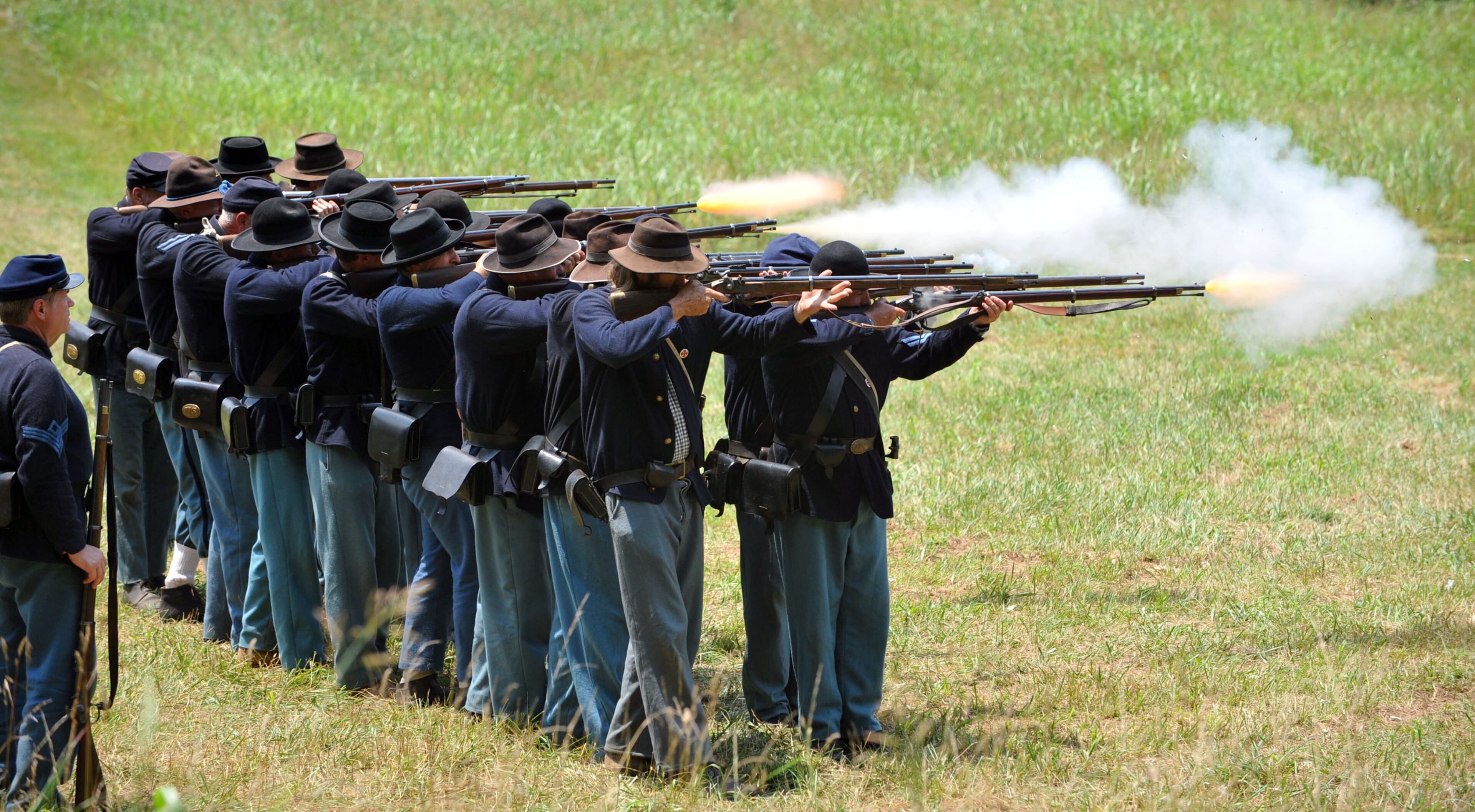 Union infantry provide a demonstration of musket fire outside of their encampment below Kennesaw Mountain. Attendees at Kennesaw Mountain National Battlefield Park Friday, June 27, 2014. The National Park Service will hold three days of commemorative programs, battlefield tours, and living history demonstrations at sites throughout the park on June 26-29, 2014. June 27, 2014, marks 150 years since Union Major General William T. Sherman launched his frontal assault at Kennesaw Mountain against the Confederate Army of Tennessee, led by General Joseph E. Johnston. The battle was a tactical defeat for the Union army, and was General Sherman's last frontal assault of the Atlanta Campaign.