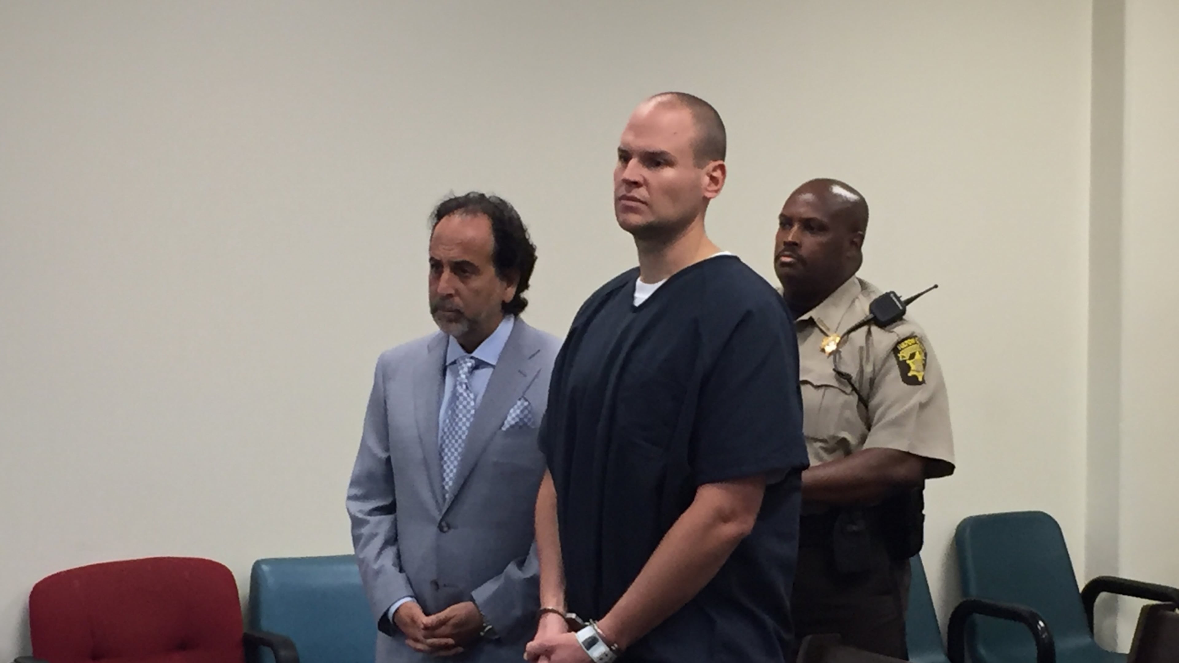 Former Atlanta police officer James R. Burns, foreground, appeared in court Monday at the Fulton County Jail, where he is being held pending a preliminary hearing Aug. 1. At left is his attorney, Drew Findling. credit: BRAD SCHRADE / BRAD.SCHRADE@AJC.COM