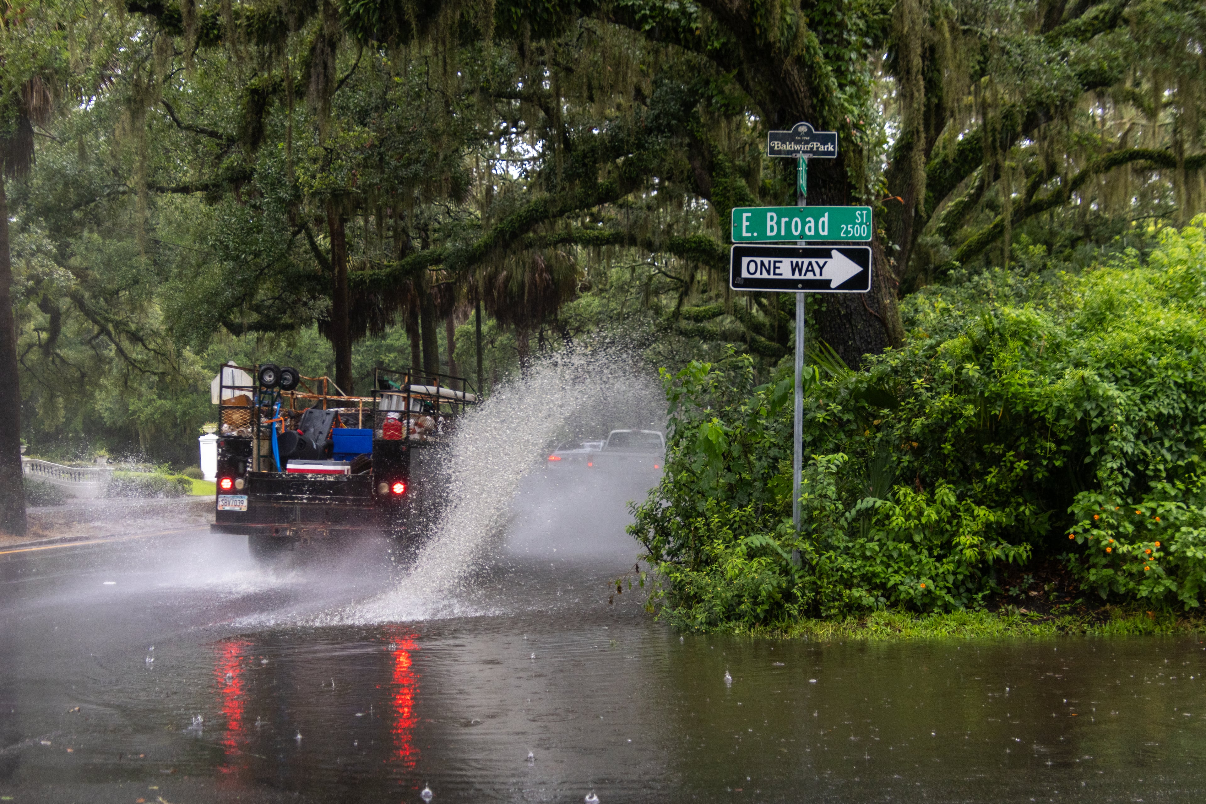 A car drives through a flooded street on Monday, August 5, 2024 in Savannah, GA. (AJC Photo/Katelyn Myrick)