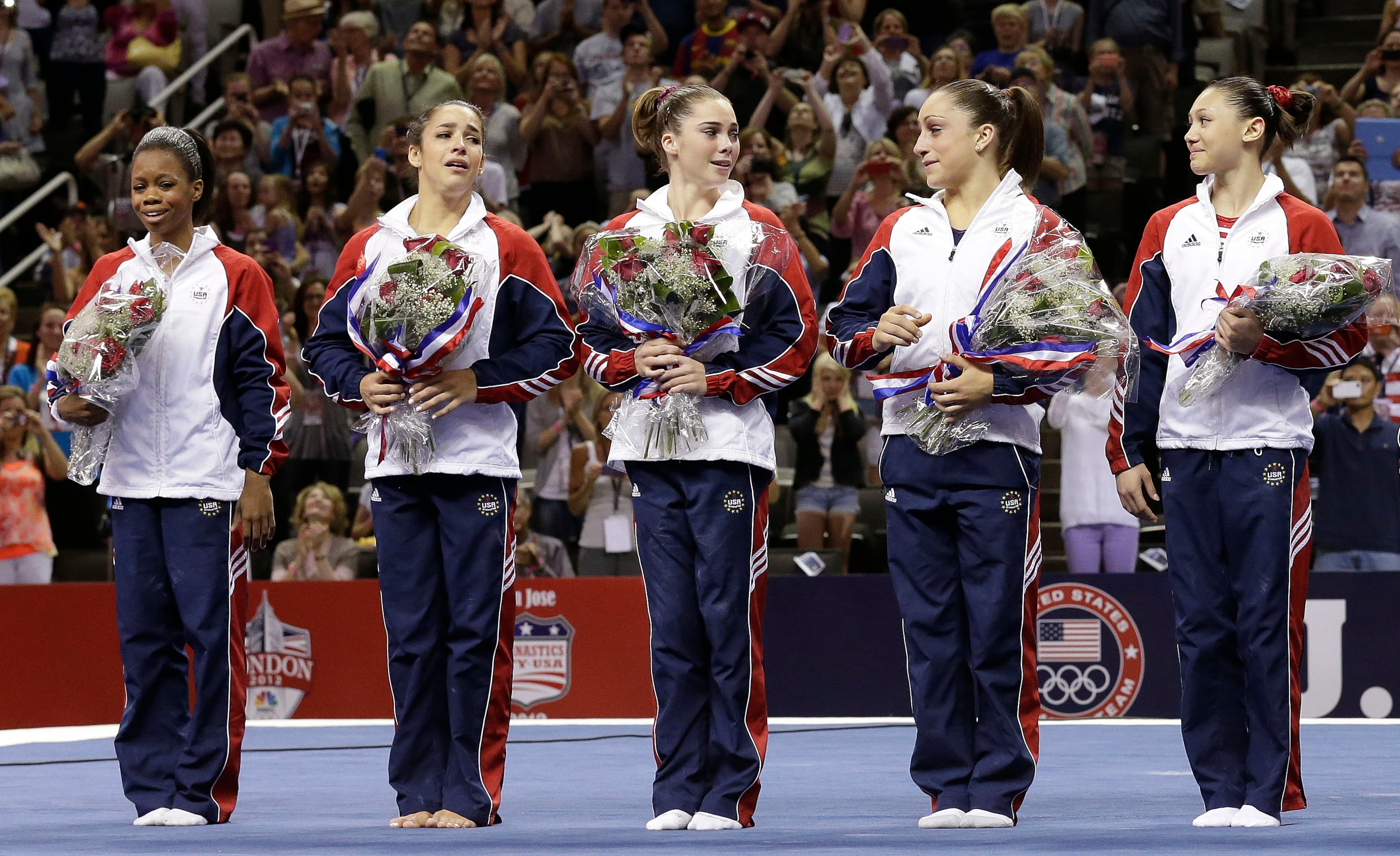 From left, Gabby Douglas, Aly Raisman, McKayla Maroney, Jordyn Wieber and Sarah Finnegan react while standing on the podium after being announced as members of the U.S. women's Olympic gymnastics team after the final round of the women's Olympic gymnastics trials, Sunday, July 1, 2012, in San Jose, Calif. (AP Photo/Gregory Bull)