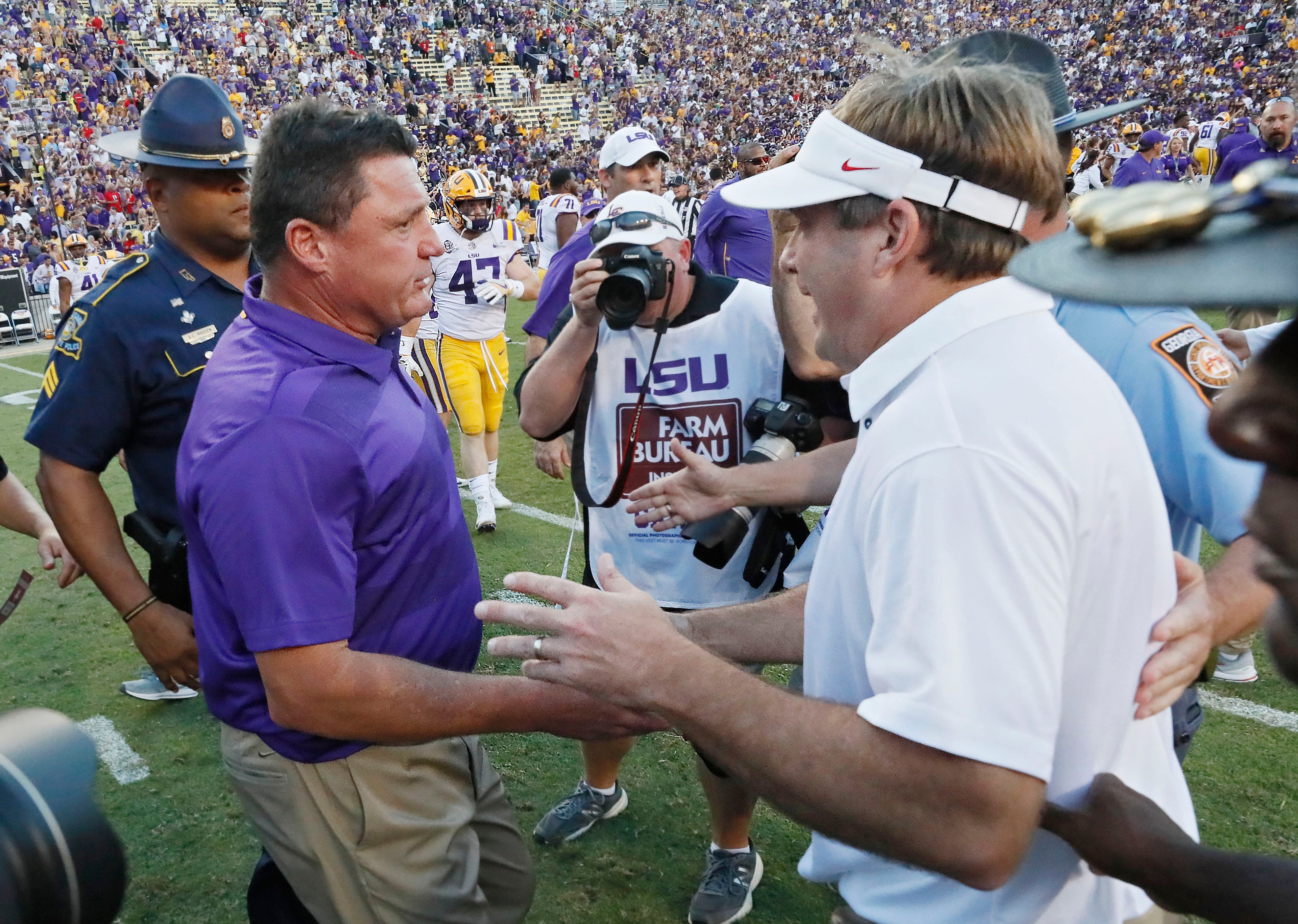 10/13/18 - Baton Rouge - Tigers head coach Ed Orgeron (left) is congratulated by Bulldogs head coach Kirby Smart after the game. The Tigers won 36-16. The University of Georgia Bulldogs played the Louisiana State University Tigers in a NCAA college football game Saturday, October 13, 2018, at Tiger Stadium in Baton Rouge, LA. BOB ANDRES / BANDRES@AJC.COM