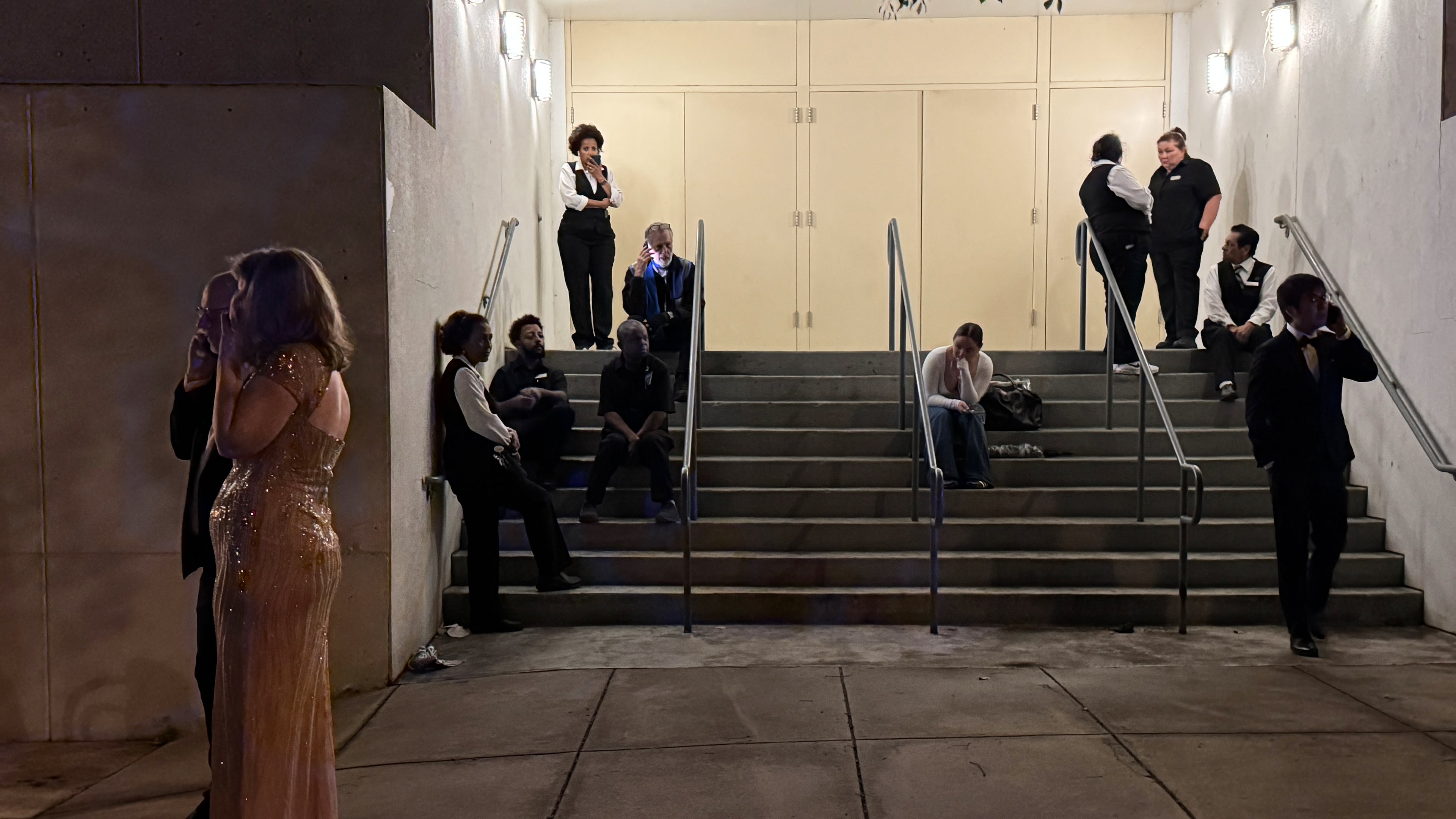 Attendees and hotel workers evacuate after an incident at the Washington Hilton during the White House Correspondents Dinner, Saturday, April 25, 2026, in Washington. (AP Photo/Mark Schiefelbein)