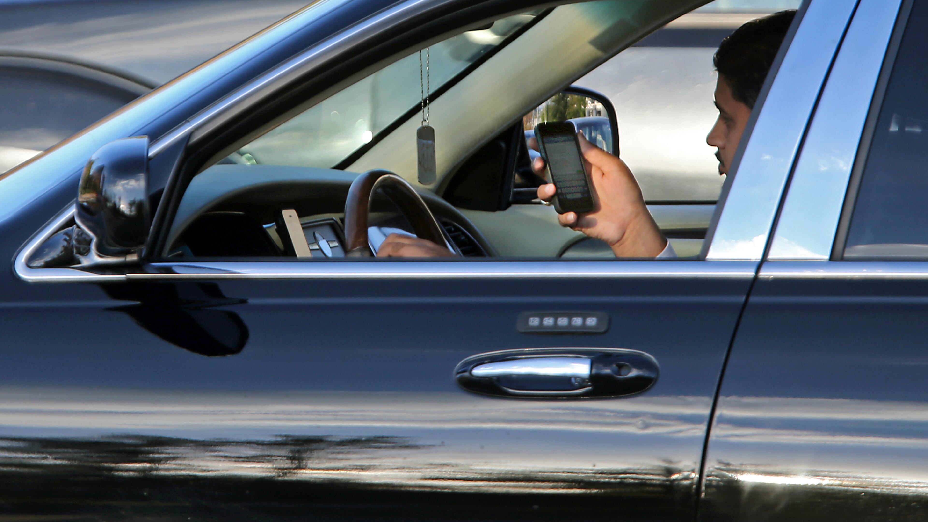 Georgia lawmakers may raise fines for distracted driving. JASON GETZ / JGETZ@AJC.COM