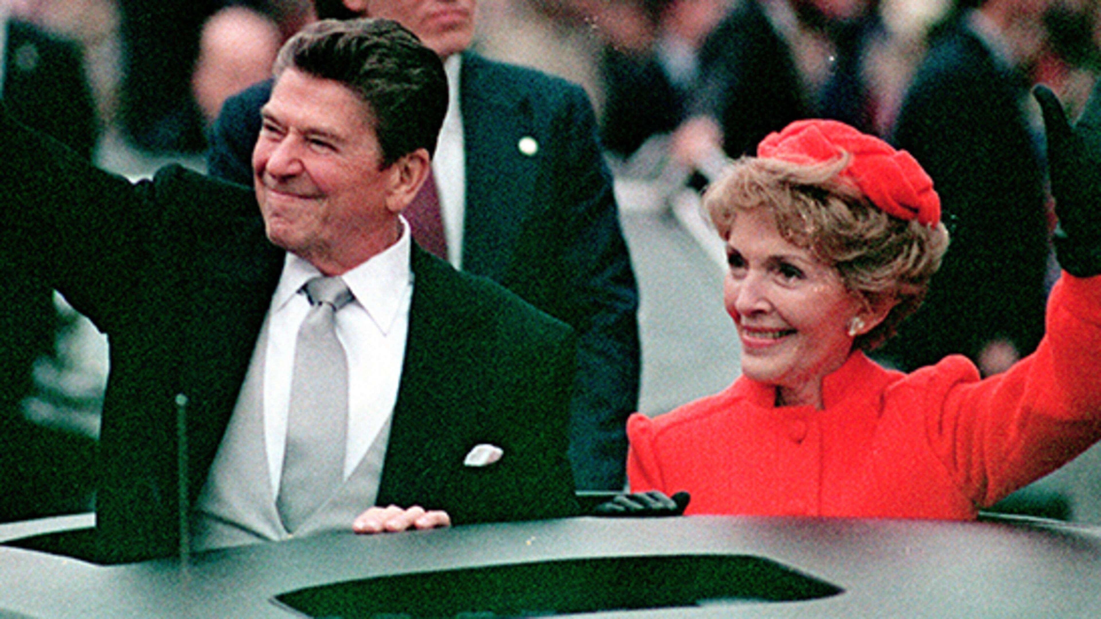 This Jan. 20, 1981 file photo, shows President Ronald Reagan as he gives a thumbs up to the crowd while his wife, first lady Nancy Reagan, waves from a limousine during the inaugural parade in Washington following Reagan's swearing in as the 40th president of the United States. Sunday, Feb. 6, 2011, marks the centennial anniversary of Reagan's birth.