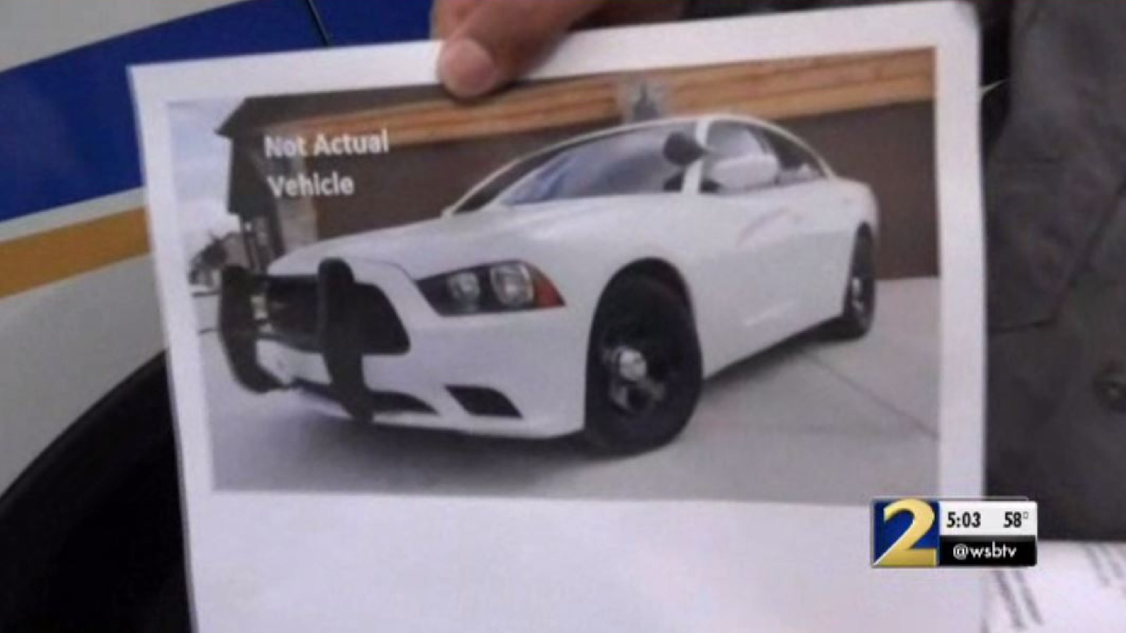 Authorities are searching for two men who posed as police officers, accused of robbing a couple at gunpoint during a "traffic stop."