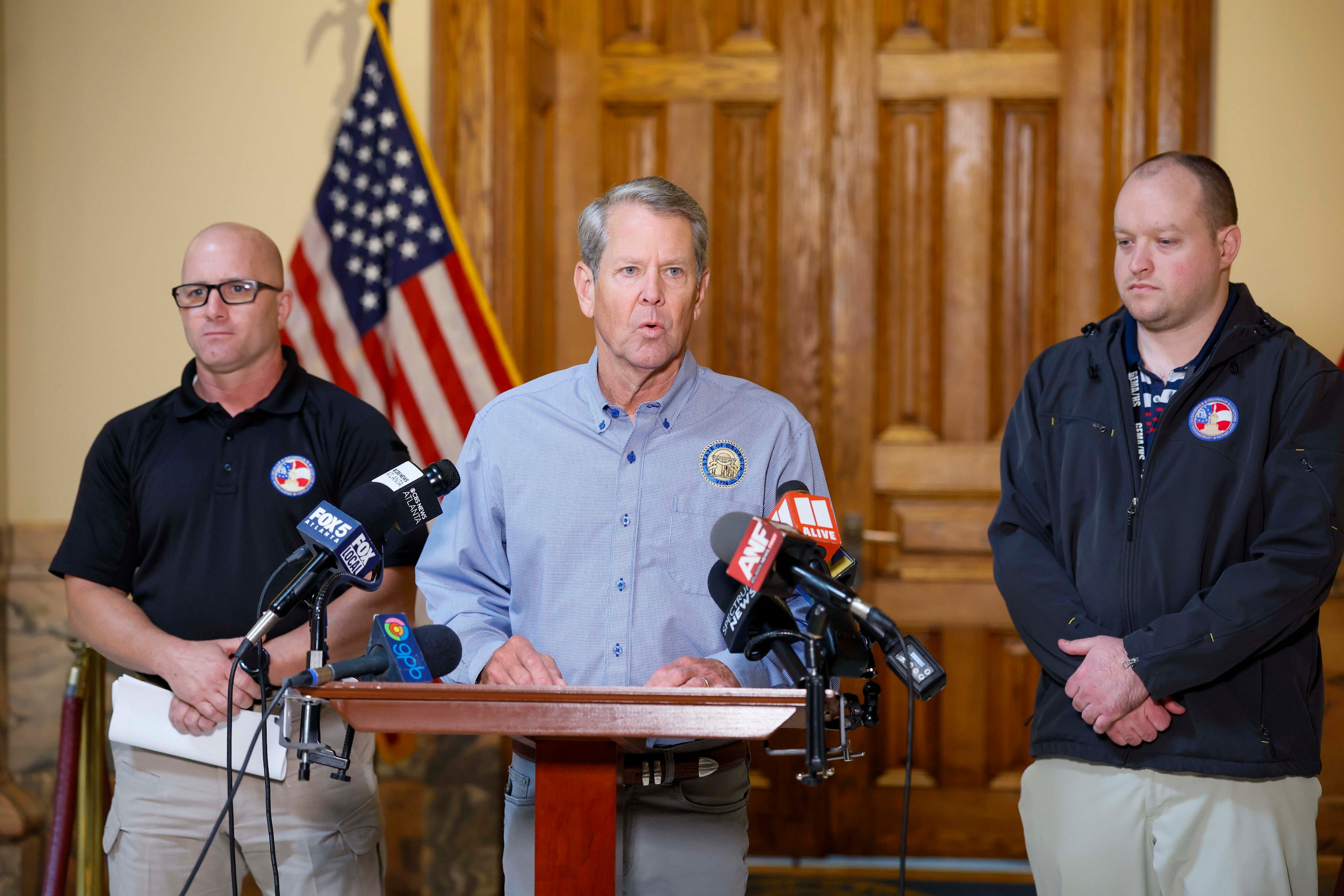 Gov. Brian Kemp (center), accompanied by Georgia Emergency Management and Homeland Security Agency Director Josh Lamb (left) and GEMA meteorologist Will Lanxton, briefs reporters during a news conference at the state Capitol on Thursday, Oct. 8, 2026, in Atlanta. Kemp announced a state of emergency as Georgia prepares for impacts from Hurricane Isaias. (Miguel Martinez/AJC)