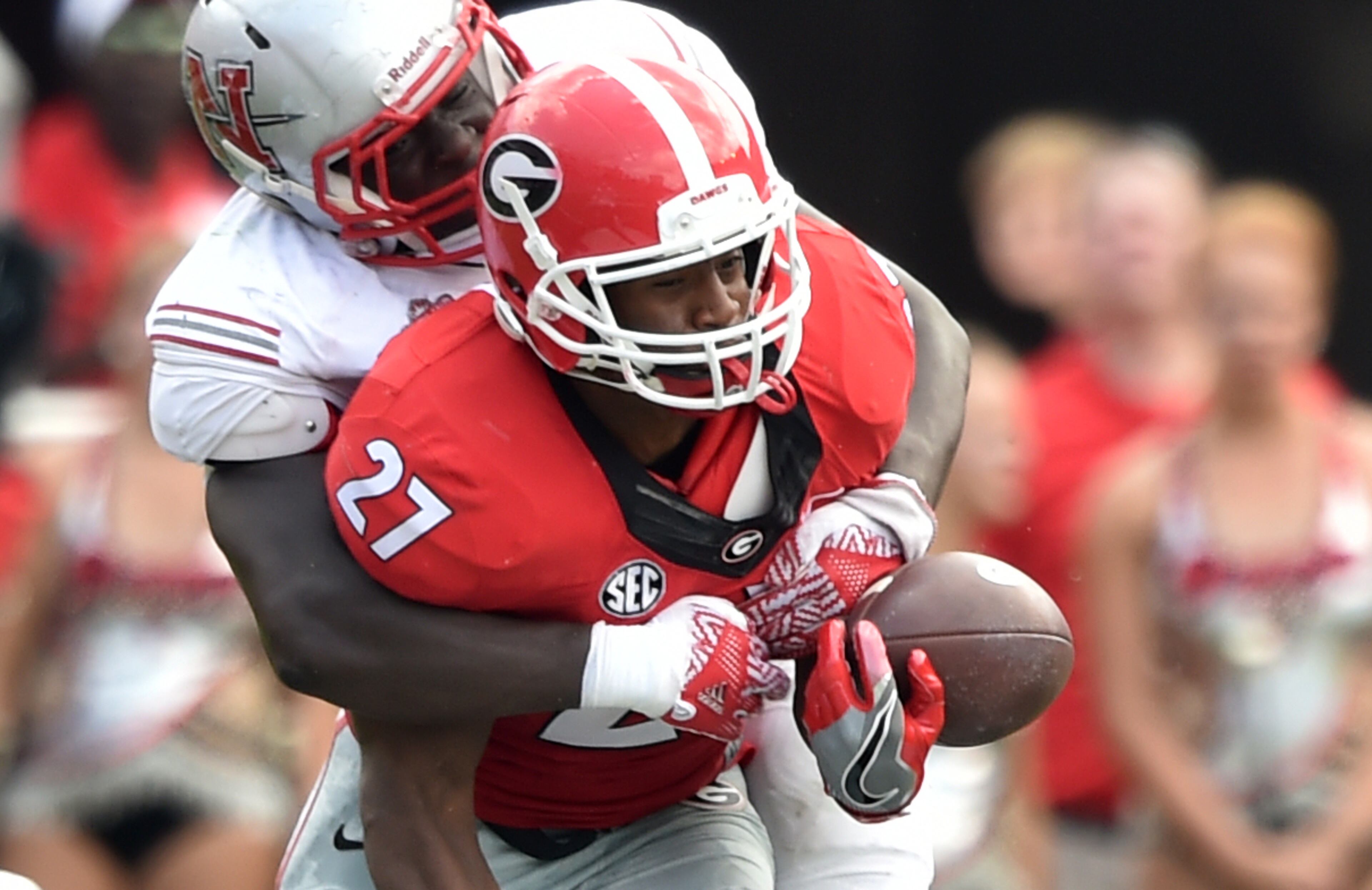 September 10, 2016 Athens, GA: Georgia Bulldogs running back Nick Chubb fumbles as he is hit by Nicholls State Colonels defensive lineman Kenny Dotson during the second quarter at Sanford Stadium Saturday September 10, 2016. The fumble setup a Nicholls State touchdown. BRANT SANDERLIN/BSANDERLIN@AJC.COM