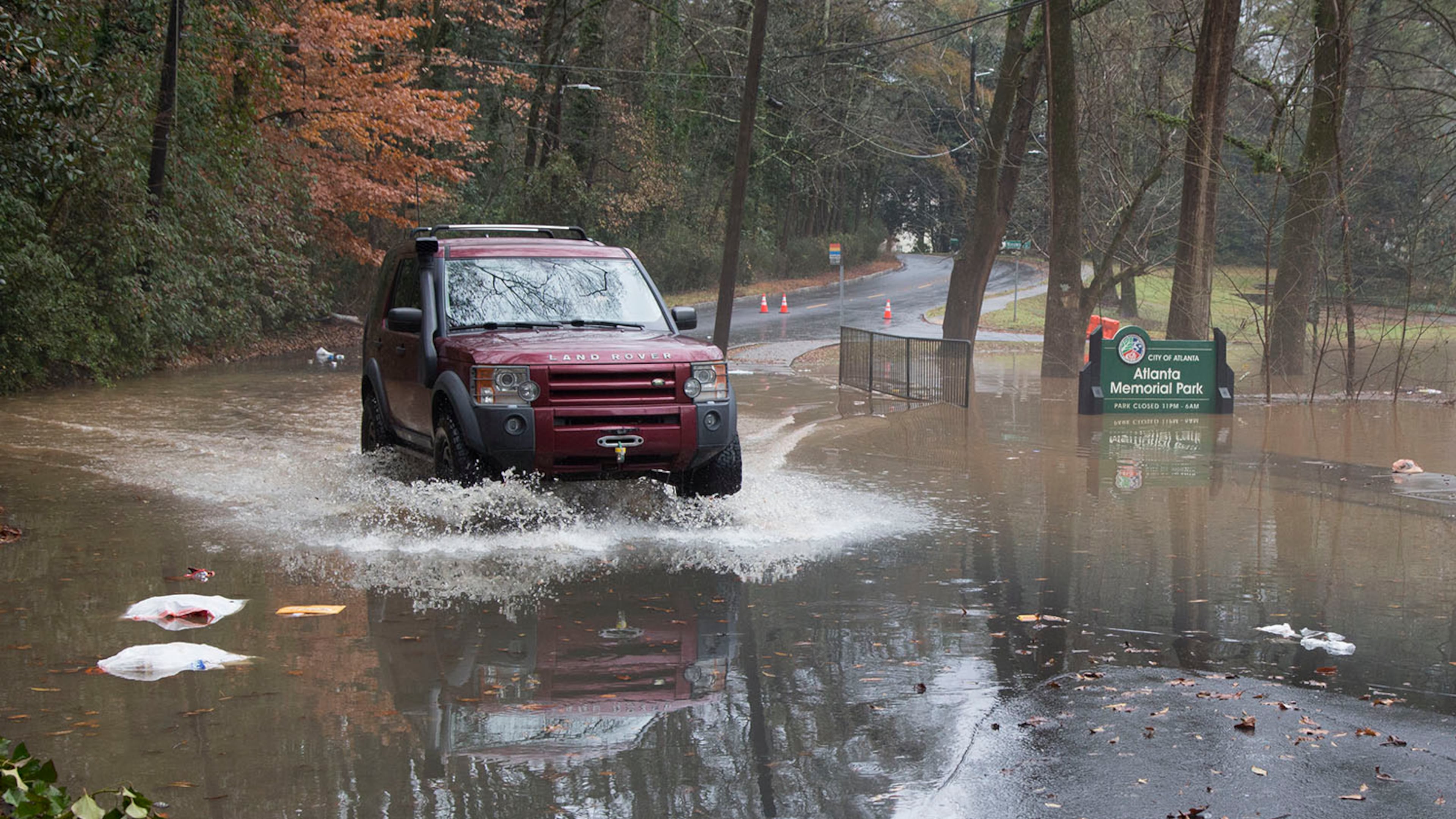 An SUV drives through floodwaters covering parts of Peachtree Battle Ave after the Peachtree Creek overflowed it's banks with rain water on Friday December 28th, 2018. (Photo by Phil Skinner)