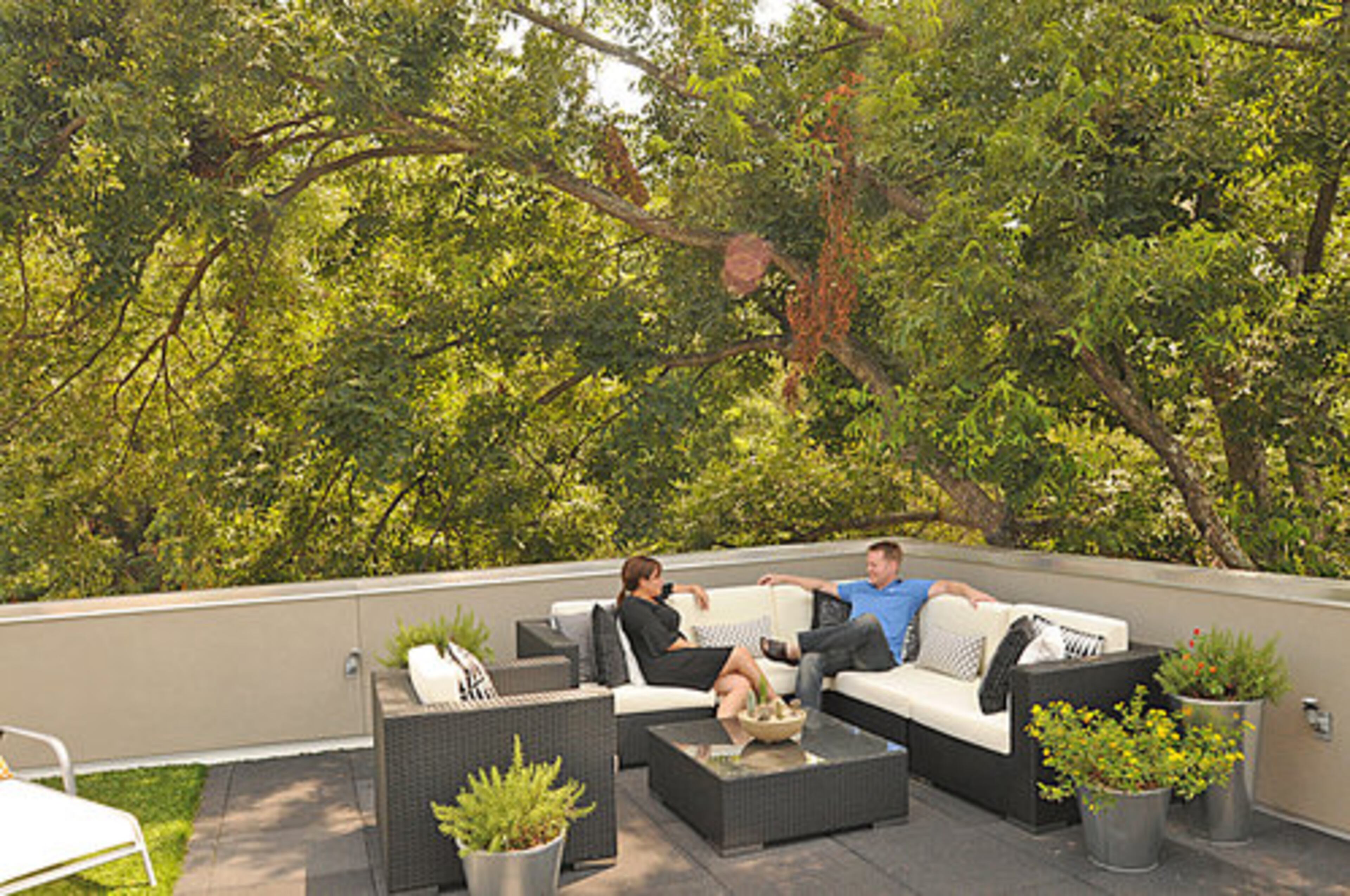This great rooftop terrace is one of the home's best features. Continuing with the interior decor style, the outdoor area features furniture and planters with a modern, minimalist design. The couple and their guests can relax in the canopy of trees and enjoy views of the Atlanta skyline.