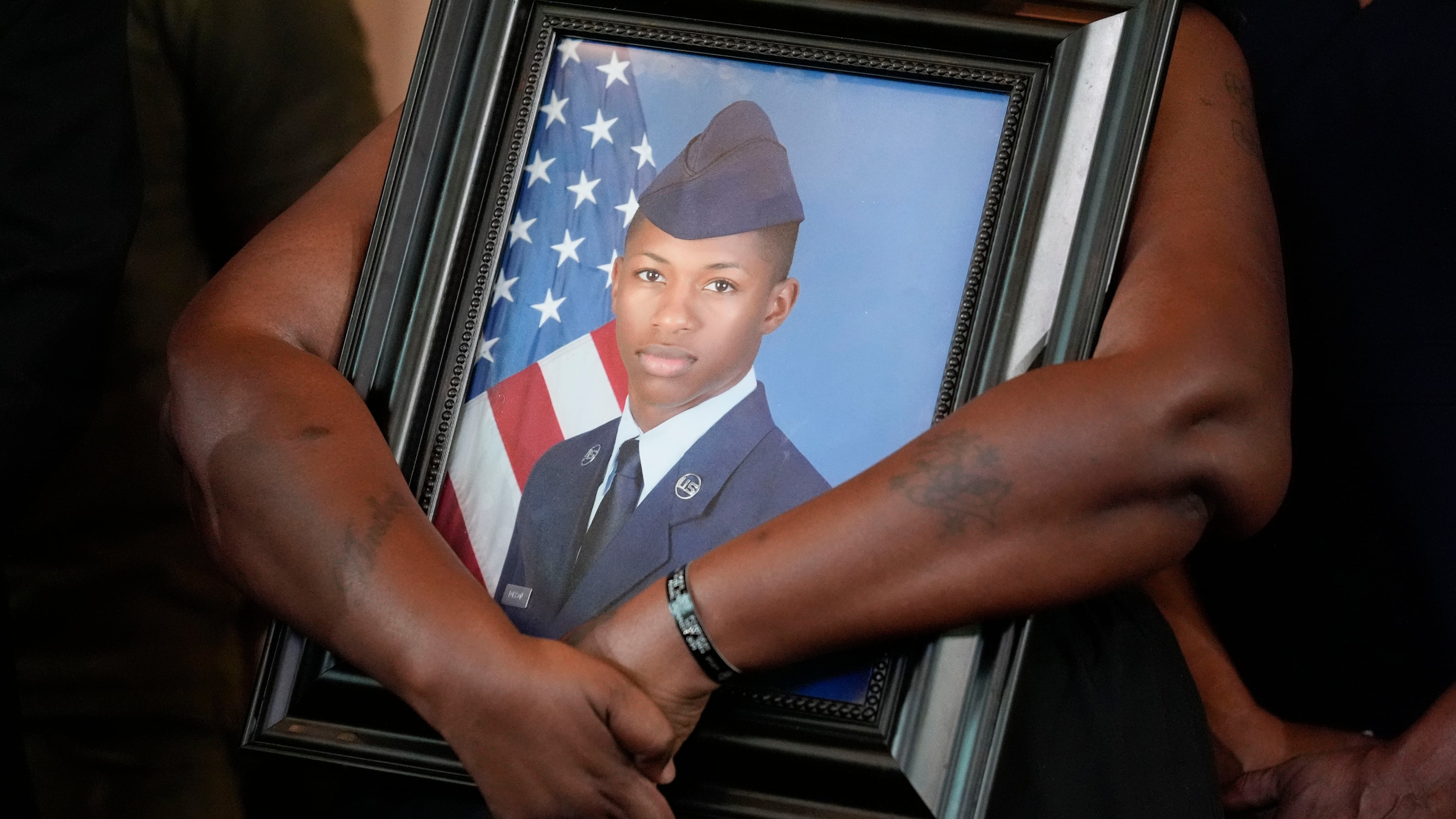 FILE - Chantemekki Fortson, mother of slain U.S. Air Force senior airman Roger Fortson, holds a photo of her son during a news conference with attorney Ben Crump on June 3, 2024, in Atlanta. (AP Photo/Brynn Anderson, File)