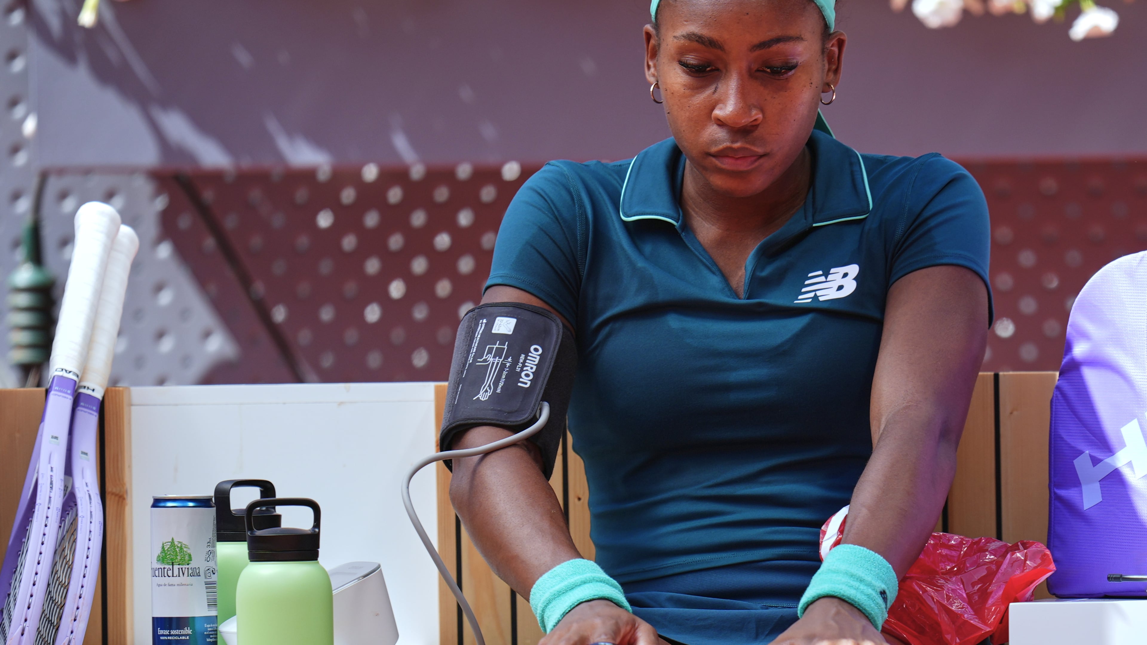 Coco Gauff of the United States receives medical attention during her match against Sorana Cirstea of Romania at the Madrid Open tennis tournament, Sunday, April 26, 2026, in Madrid. (AP Photo/Manu Fernandez)