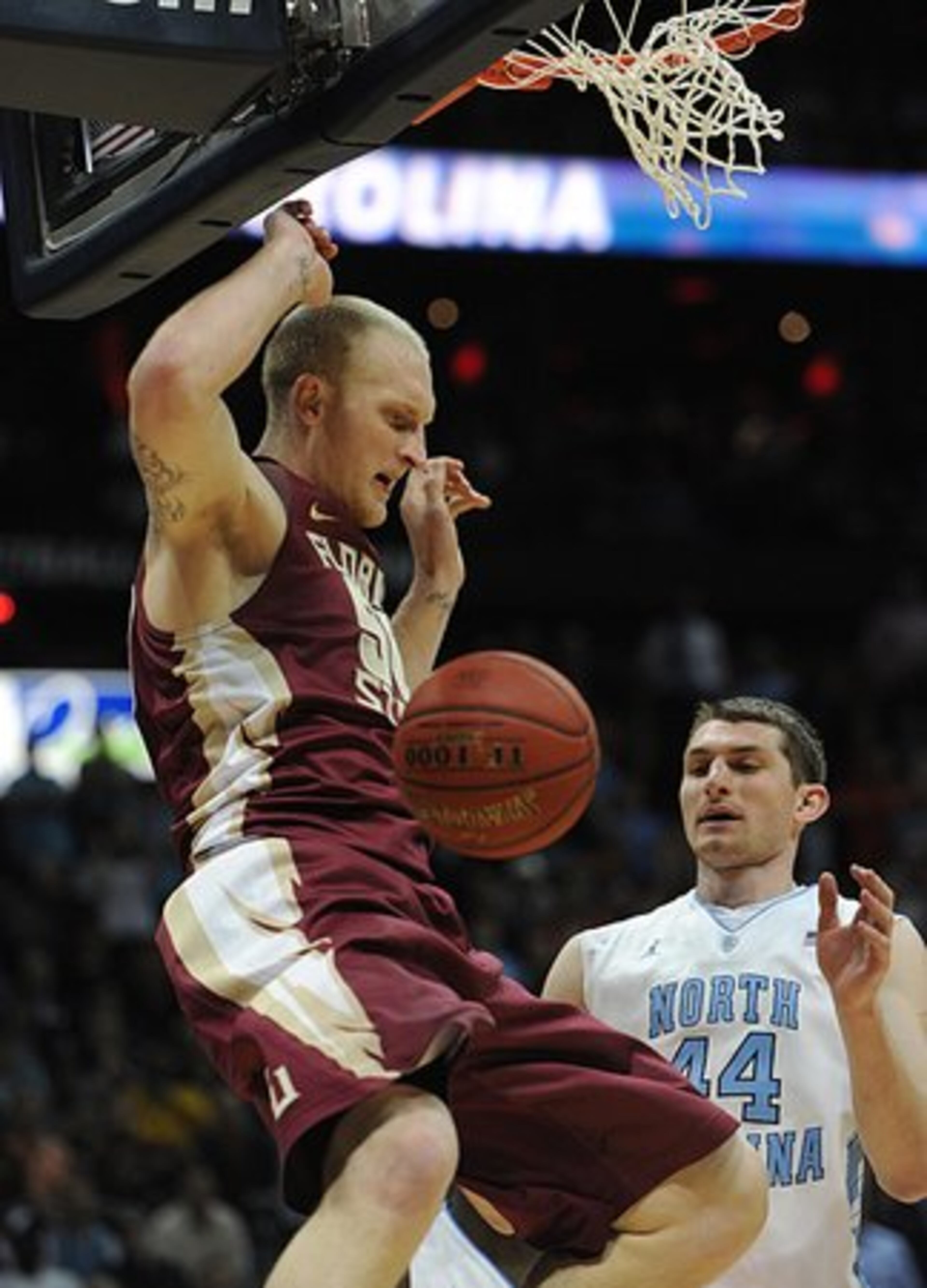 Florida State's Jon Kreft hangs in the air after dunking the ball in front of North Carolina' s Tyler Zeller.