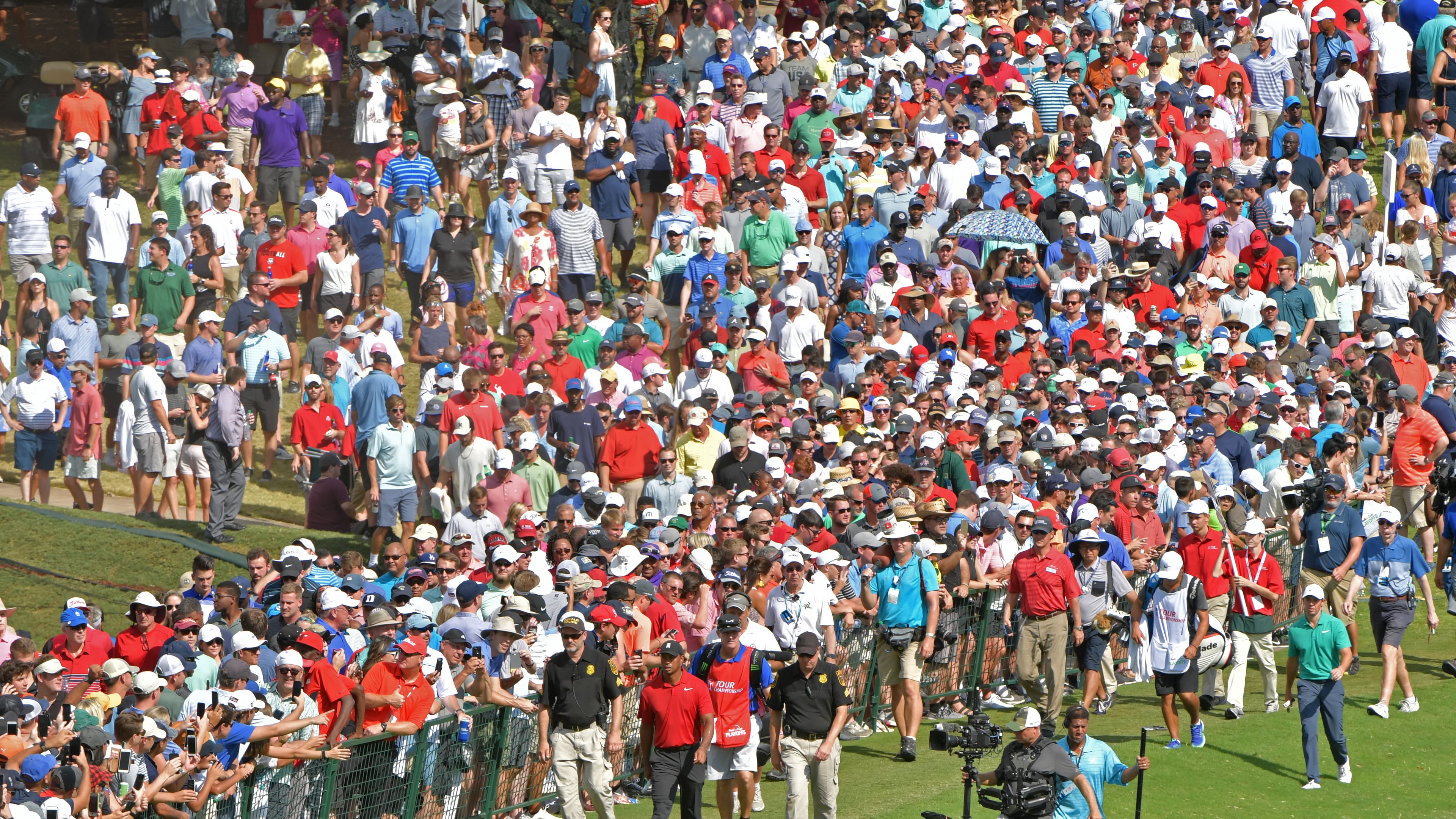 Tiger Woods tends to draw a crowd, as here on the ninth fairway at East Lake Sunday. (HYOSUB SHIN / HSHIN@AJC.COM)