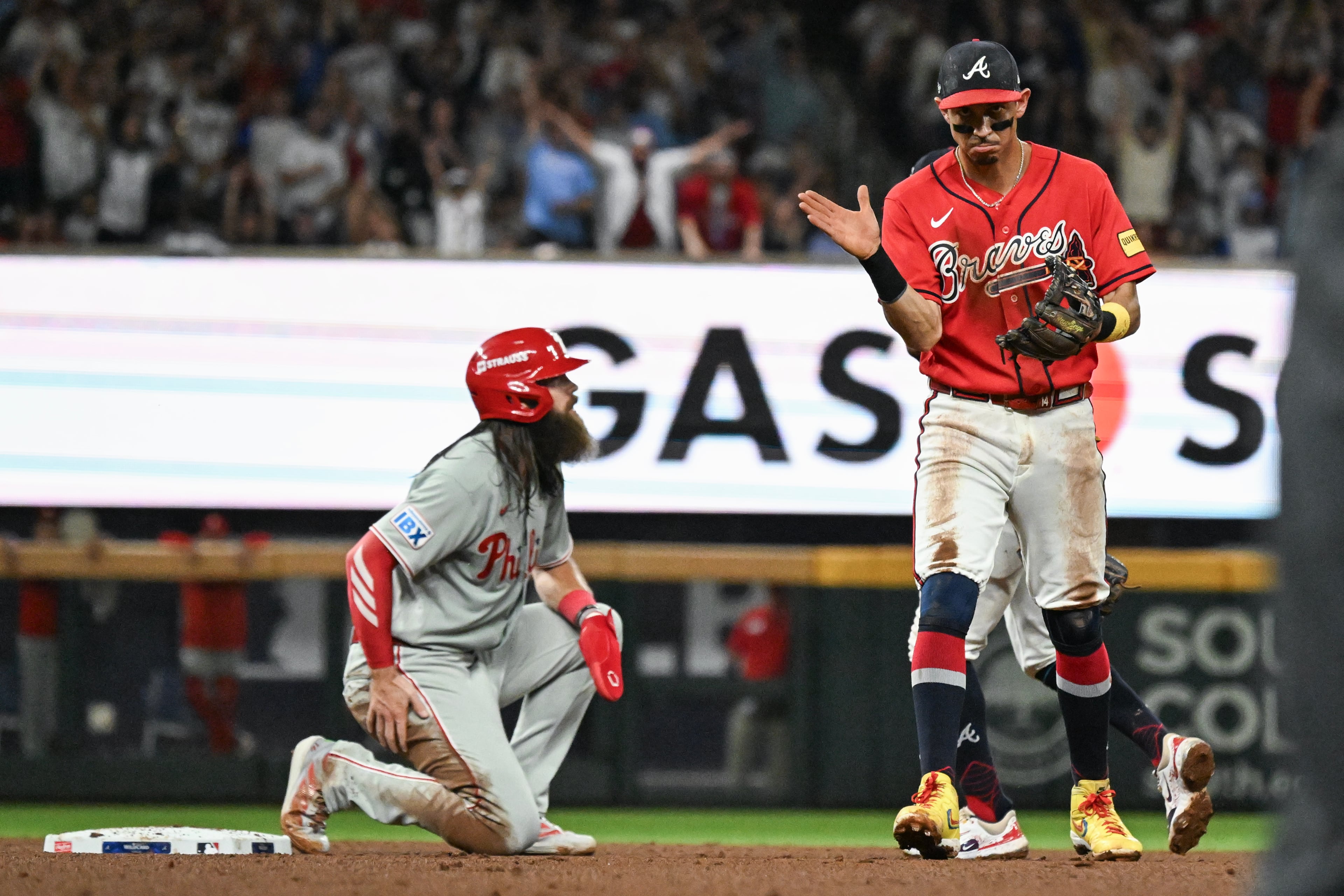 Braves left fielder Mauricio Dubón (right) claps after turning an inning-ending double play against Phillies left fielder Brandon Marsh during Game 3 of their NL Wild Card Series on Thursday, Oct. 1, 2026, in Atlanta. (Hyosub Shin/AJC)