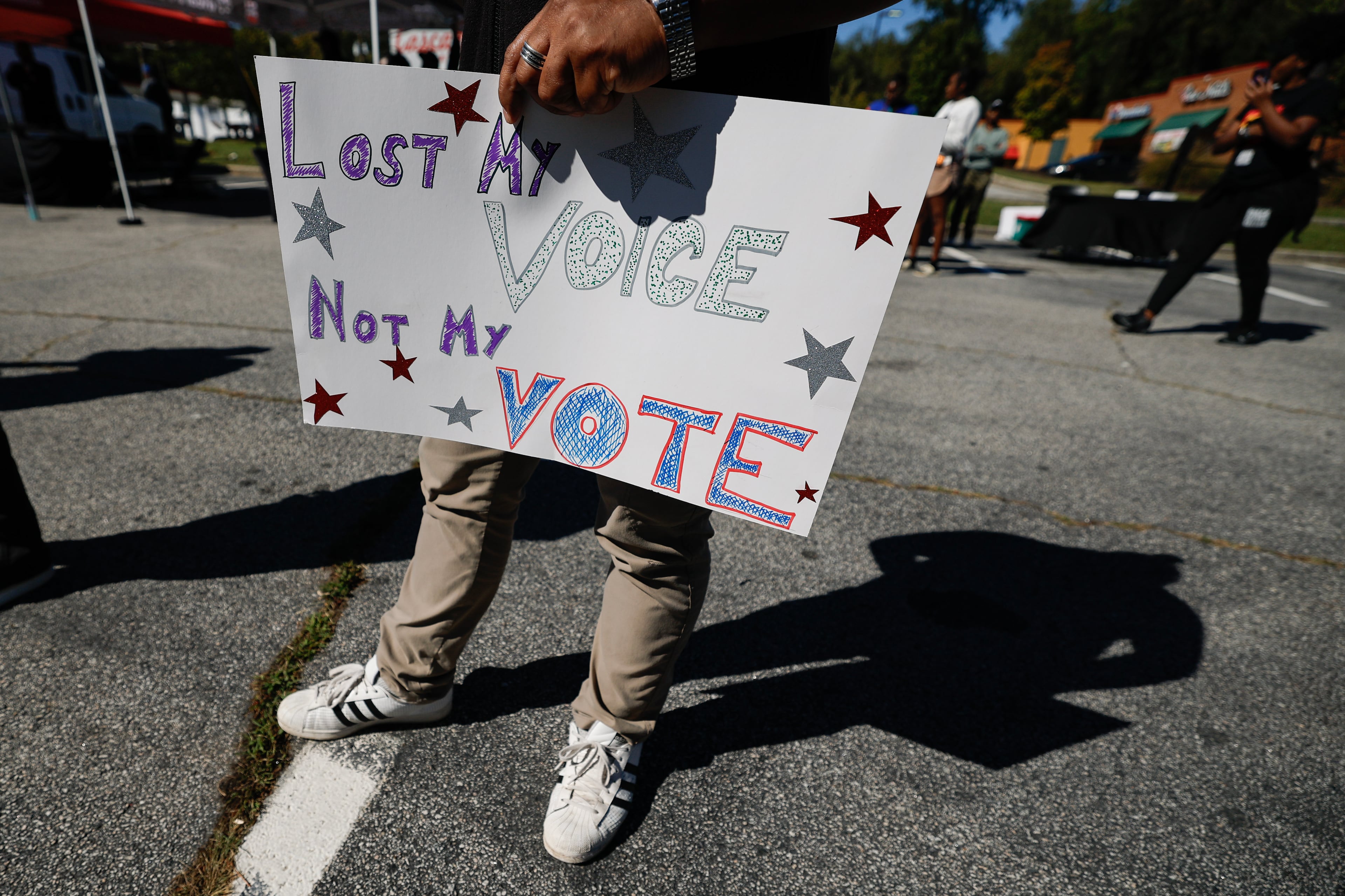A participant holds a sign during a Black Voters Matter “No Kings: Vote Early Atlanta” event at the Cascade Family Skating rink on Saturday, Oct. 17, 2026, in Atlanta. (Erik S. Lesser for the AJC)