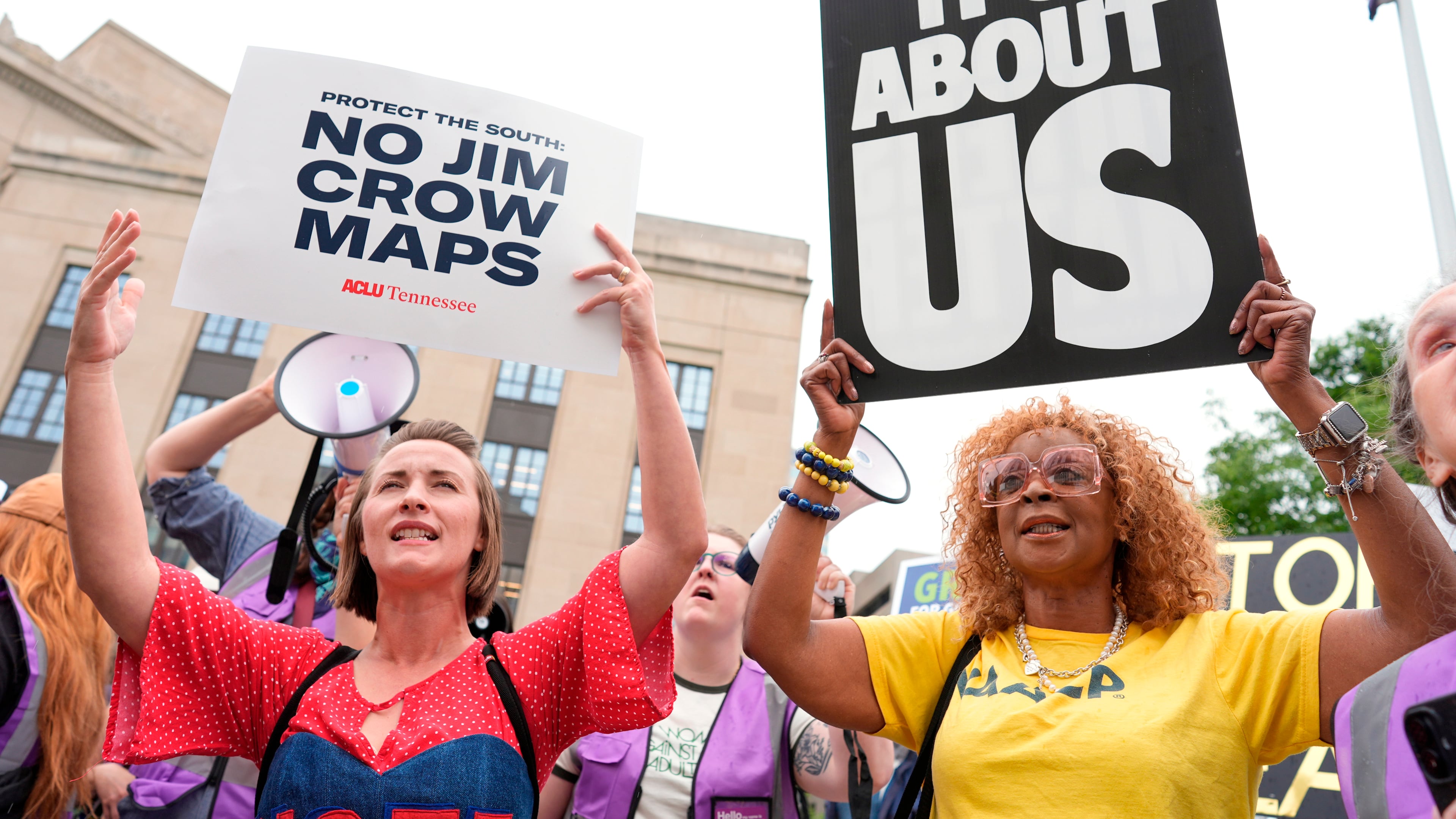 Mandy Cook, left, and Cheryl Woodard, hold signs during a rally against a special session of the state legislature to redraw U.S. Congressional voting maps Tuesday, May 5, 2026, in Nashville, Tenn. (AP Photo/George Walker IV)
