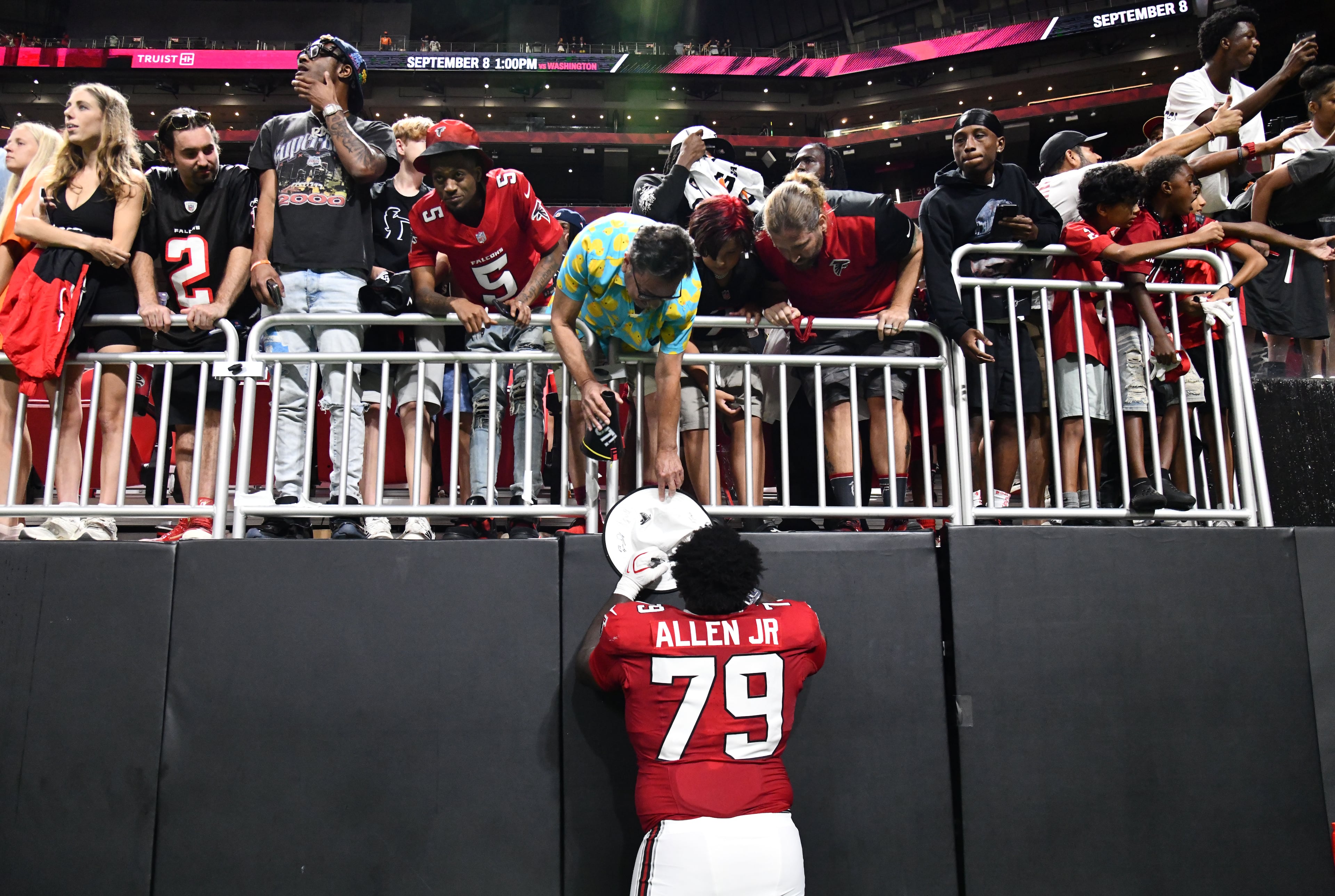 Falcons defensive tackle Carlos Allen Jr. signs autographs for fans after the Denver Broncos defeated the Atlanta Falcons, 27-7, during their preseason game at Mercedes-Benz Stadium on Friday, Aug. 14, 2026, in Atlanta. (Hyosub Shin/AJC)
