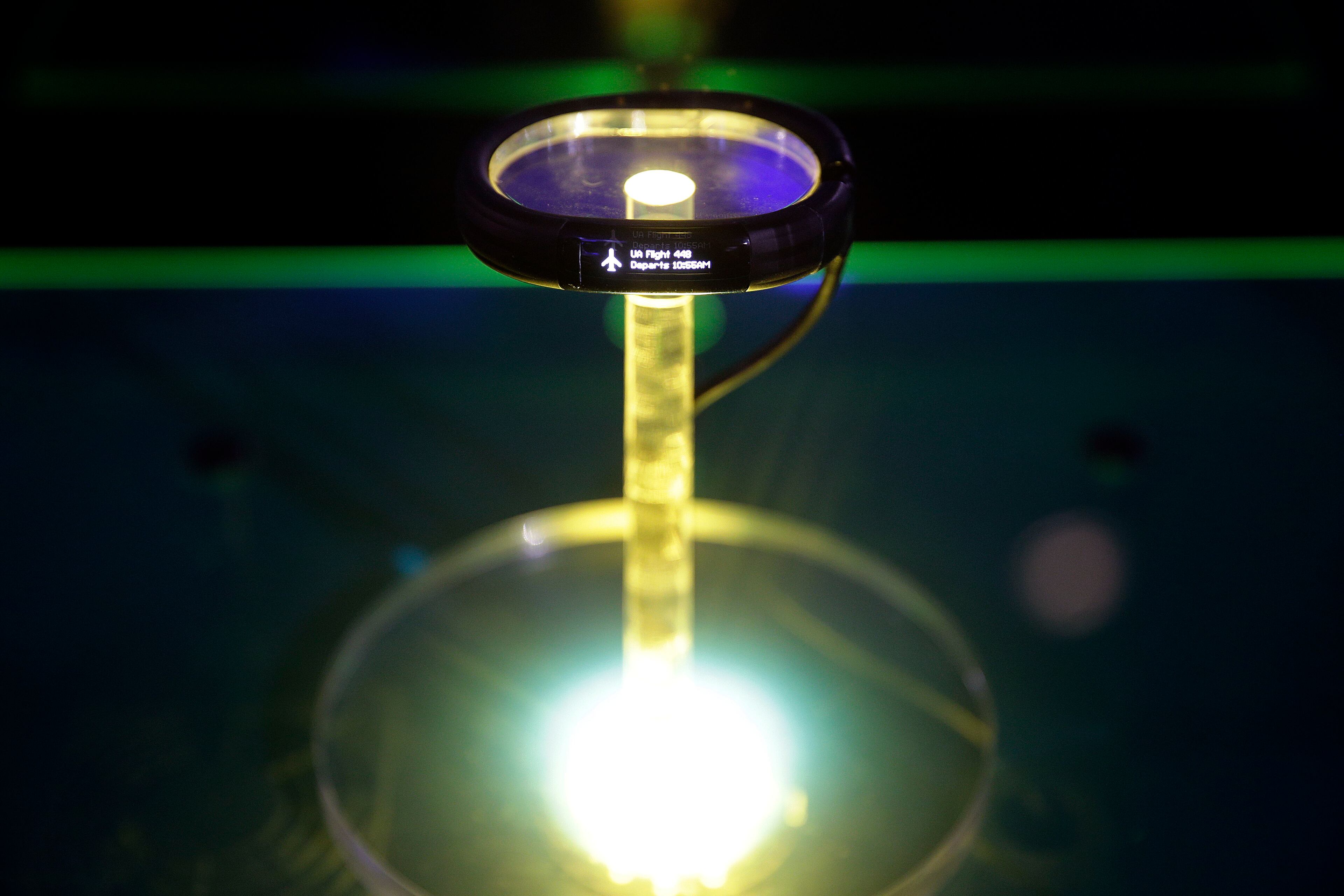 The Nabu, a wristband that acts like a fitness tracker but also serves up notifications, texts and emails like a smartwatch, is on display at the Razer booth at the International Consumer Electronics Show (CES) on Tuesday, Jan. 7, 2014, in Las Vegas. (AP Photo/Jae C. Hong)