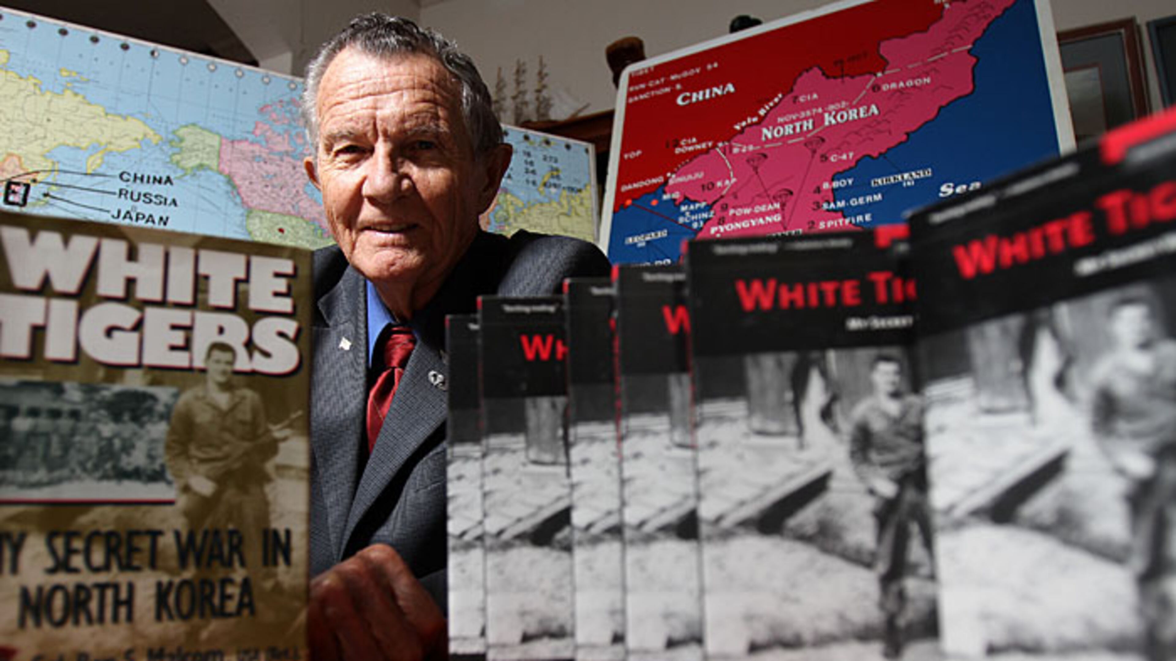 Col. Ben Malcom led guerilla fighters operating behind enemy lines in the North Korean War as a forerunner to what is known today as the U.S. Army Special Forces. Here, he is pictured with a book he wrote about his experiences. He stayed in the Army, serving in Vietnam and later commanding Fort McPherson in metro Atlanta,