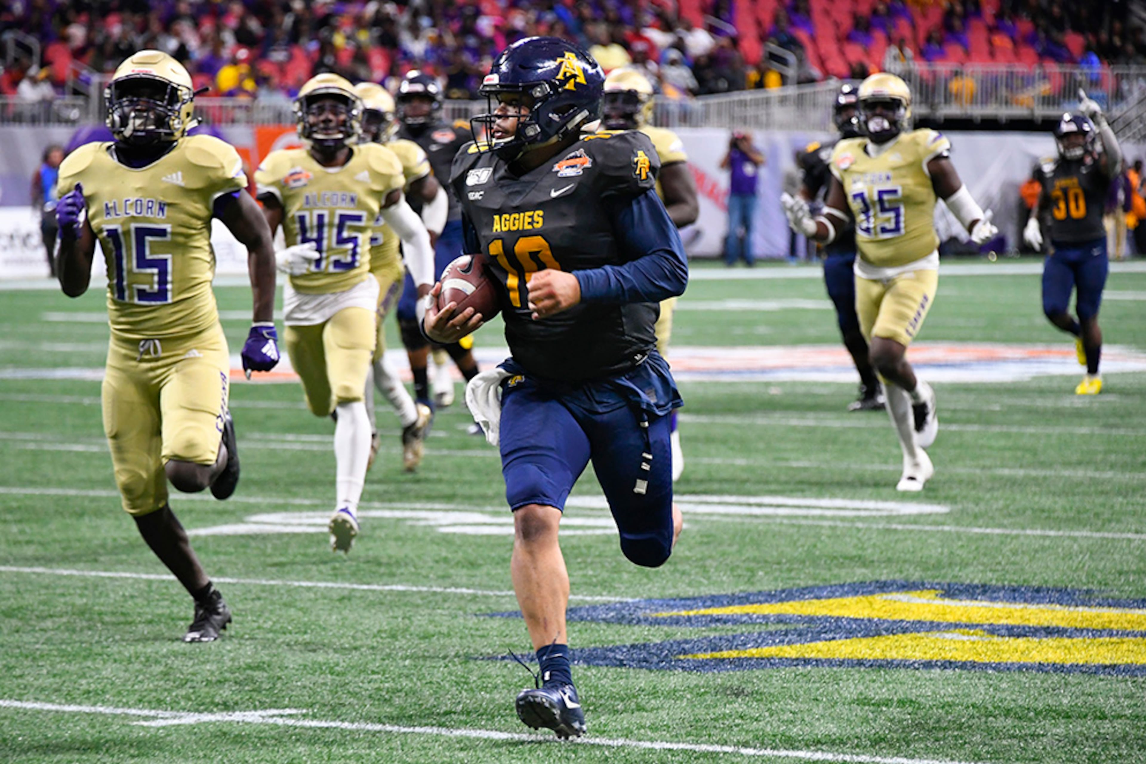 North Carolina A&T quarterback Kylil Carter is pursued by Alcorn State players during the second half of the Celebration Bowl Saturday, Dec. 21, 2019, at Mercedes-Benz Stadium in Atlanta.