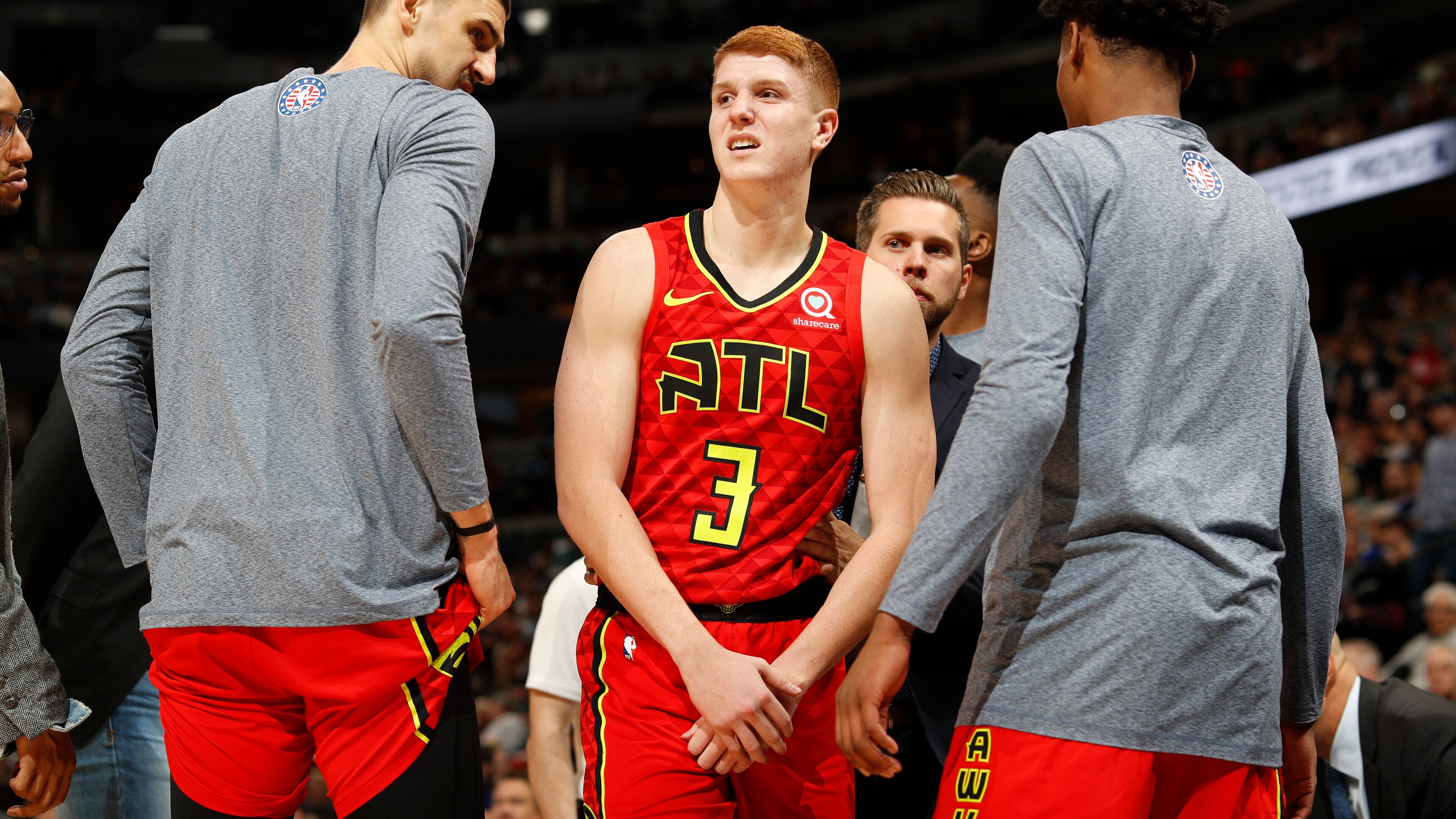 Atlanta Hawks guard Kevin Huerter holds his arm after an injury during the second half of the team's NBA basketball game agains the Denver Nuggets on Tuesday, Nov. 12, 2019, in Denver. Atlanta won 125-121. (AP Photo/David Zalubowski)
