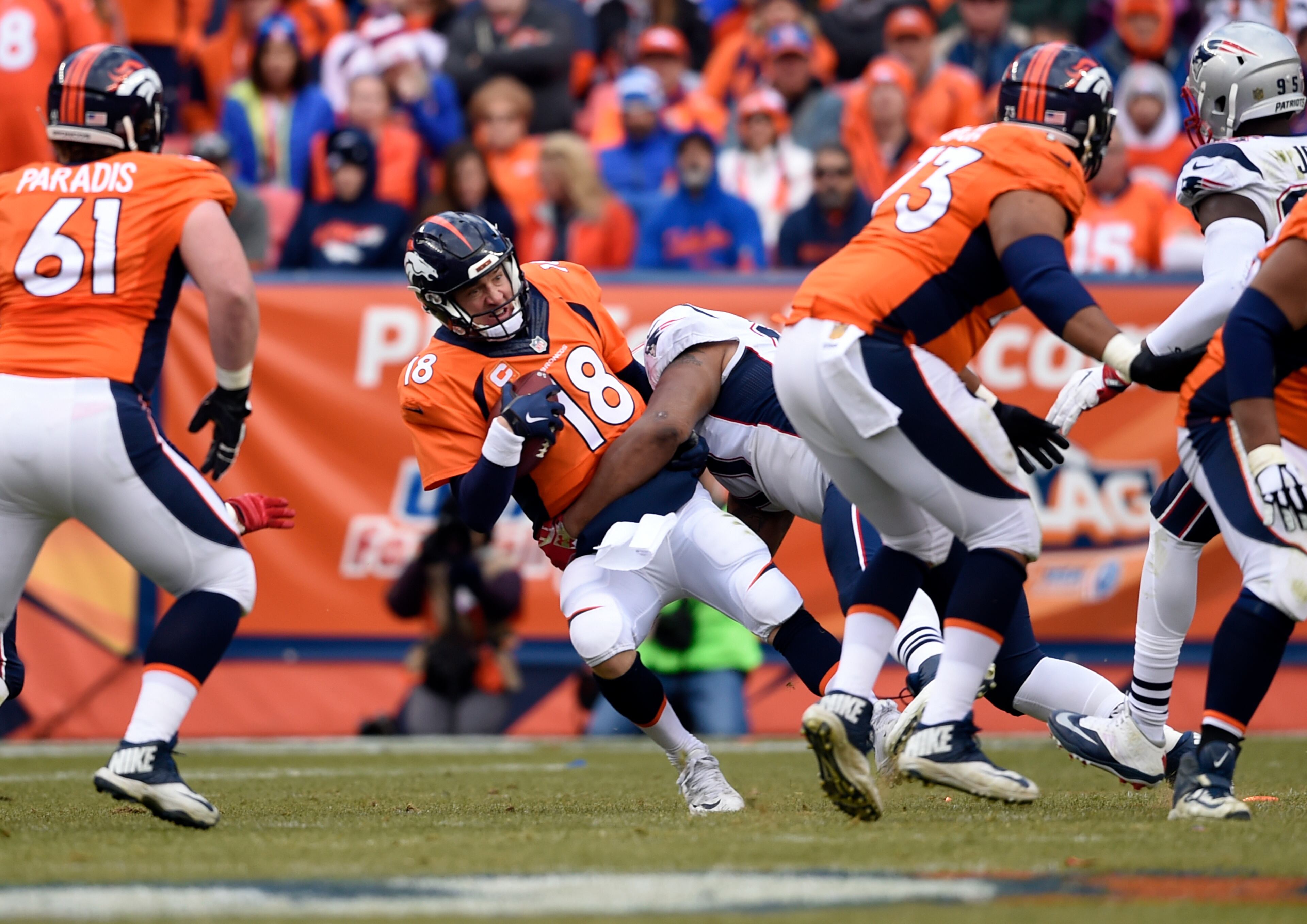 DENVER, CO - JANUARY 24: Quarterback Peyton Manning (18) of the Denver Broncos gets sacked by defensive tackle Alan Branch (97) of the New England Patriots in the second quarter. The Denver Broncos played the New England Patriots in the AFC championship game at Sports Authority Field at Mile High in Denver, CO on January 24, 2015. (Photo by Helen H. Richardson/The Denver Post via Getty Images)