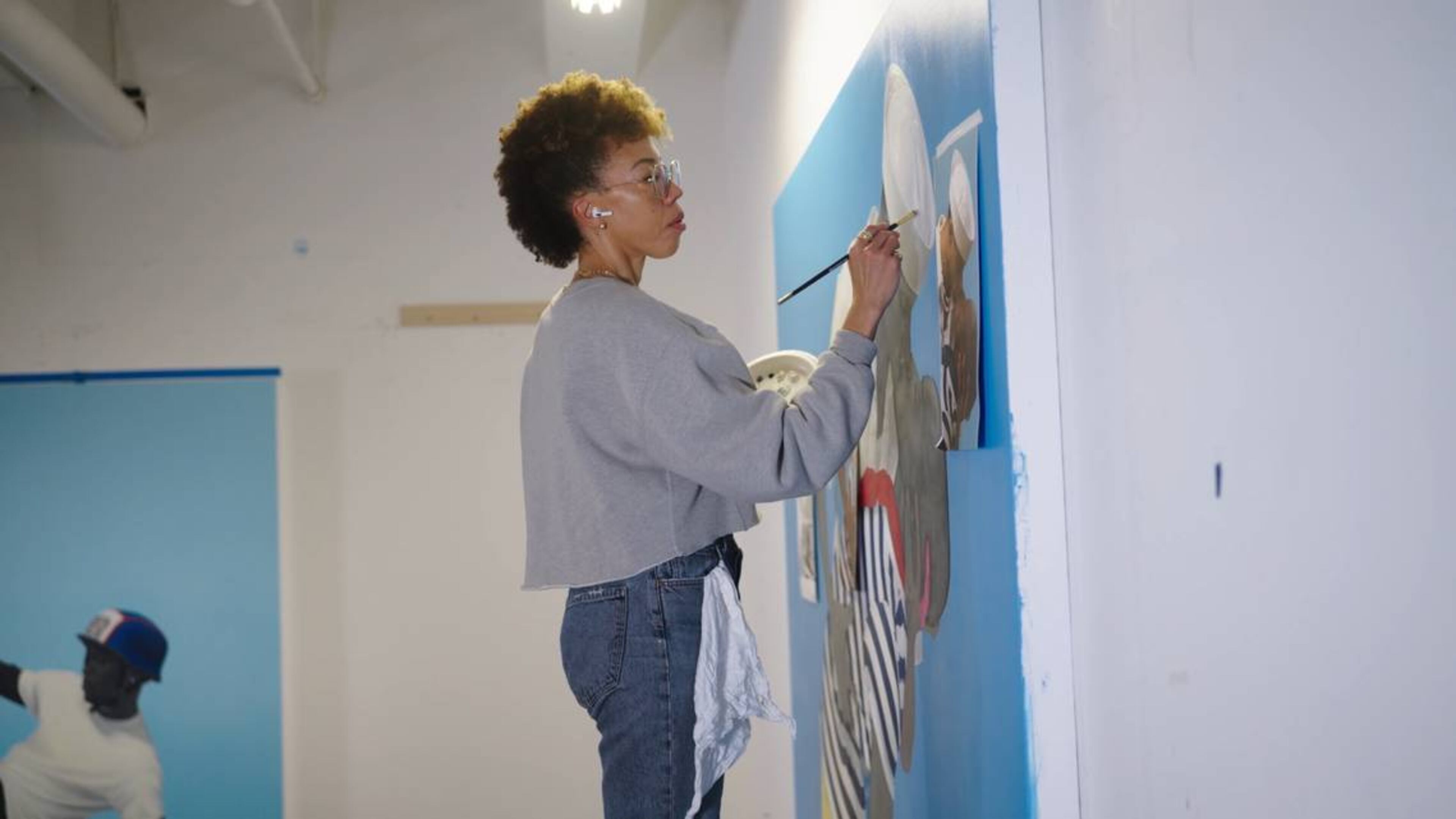 Acclaimed artist and Columbus native Amy Sherald is shown at work in her studio. (Photo Courtesy of Art21 and PBS)
