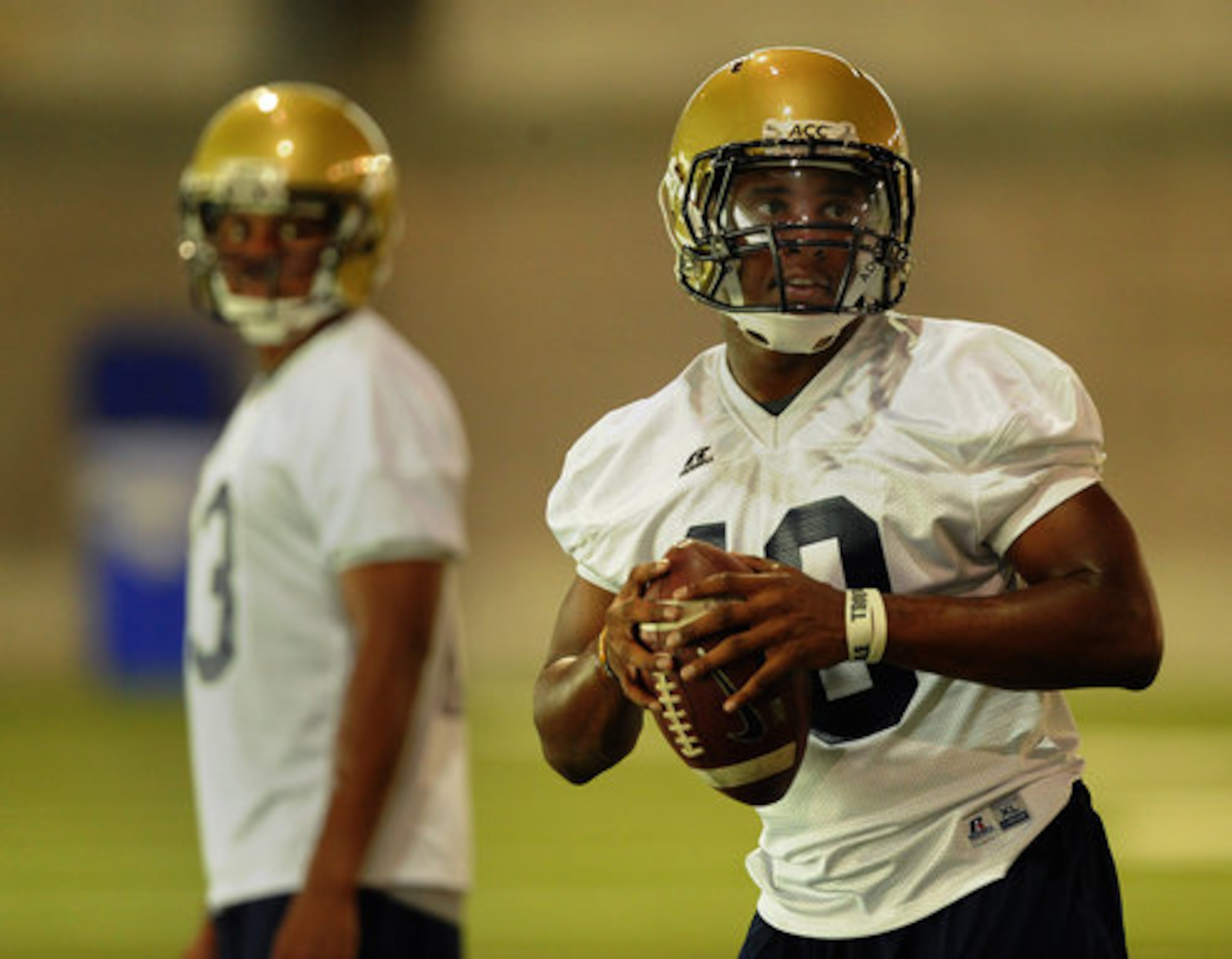 Quarterback Synjyn Days redshirted as a freshman last season and begins fall camp as the backup to Tevin Washington (left). The QBs ran drills in the indoor facility on the first day of practice.