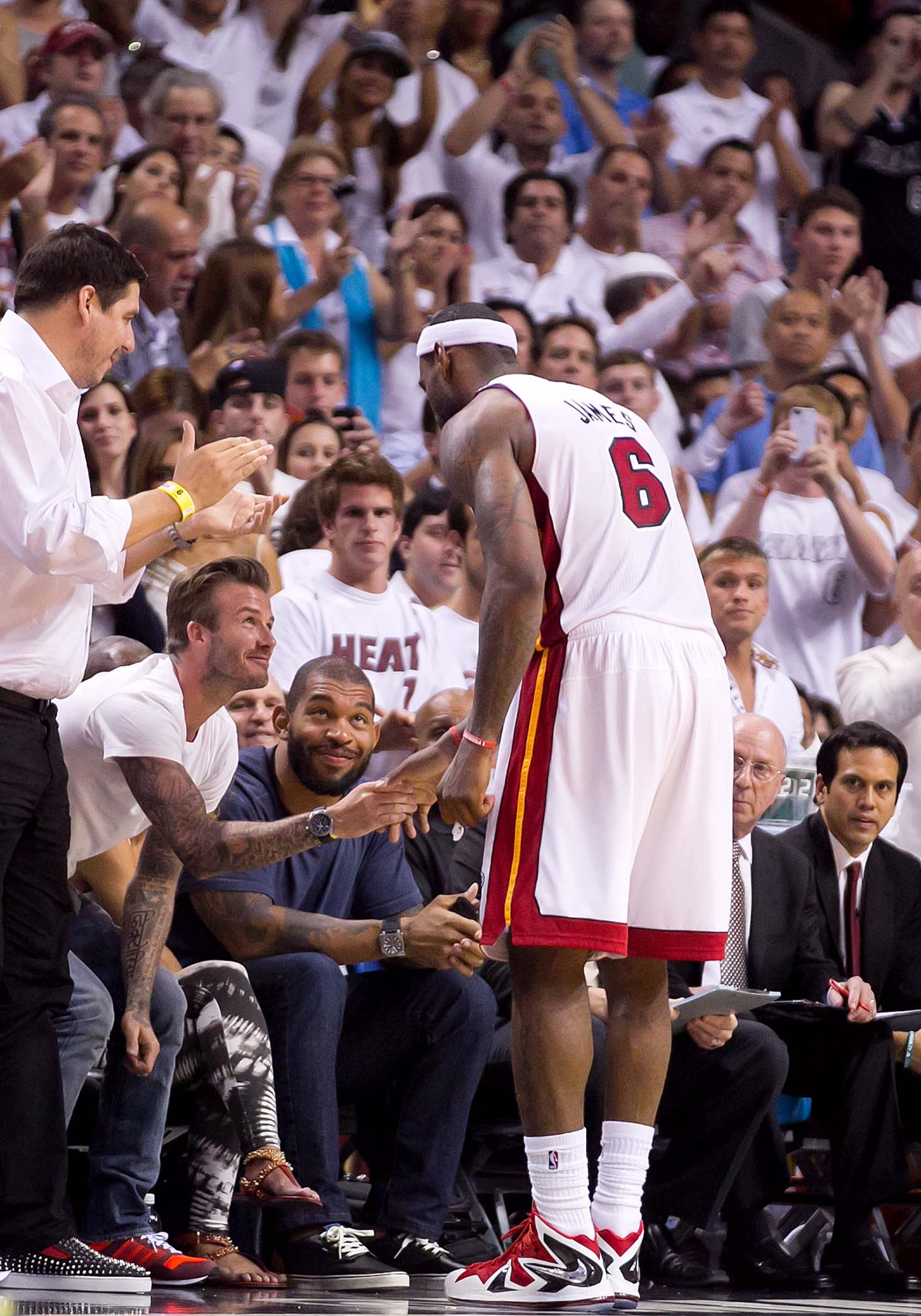 Soccer star David Beckham shakes Miami Heat small forward LeBron James (6) hand as James is taken out of the game in the fourth quarter at AmericanAirlines Arena on June 3, 2013. (Allen Eyestone/The Palm Beach Post)