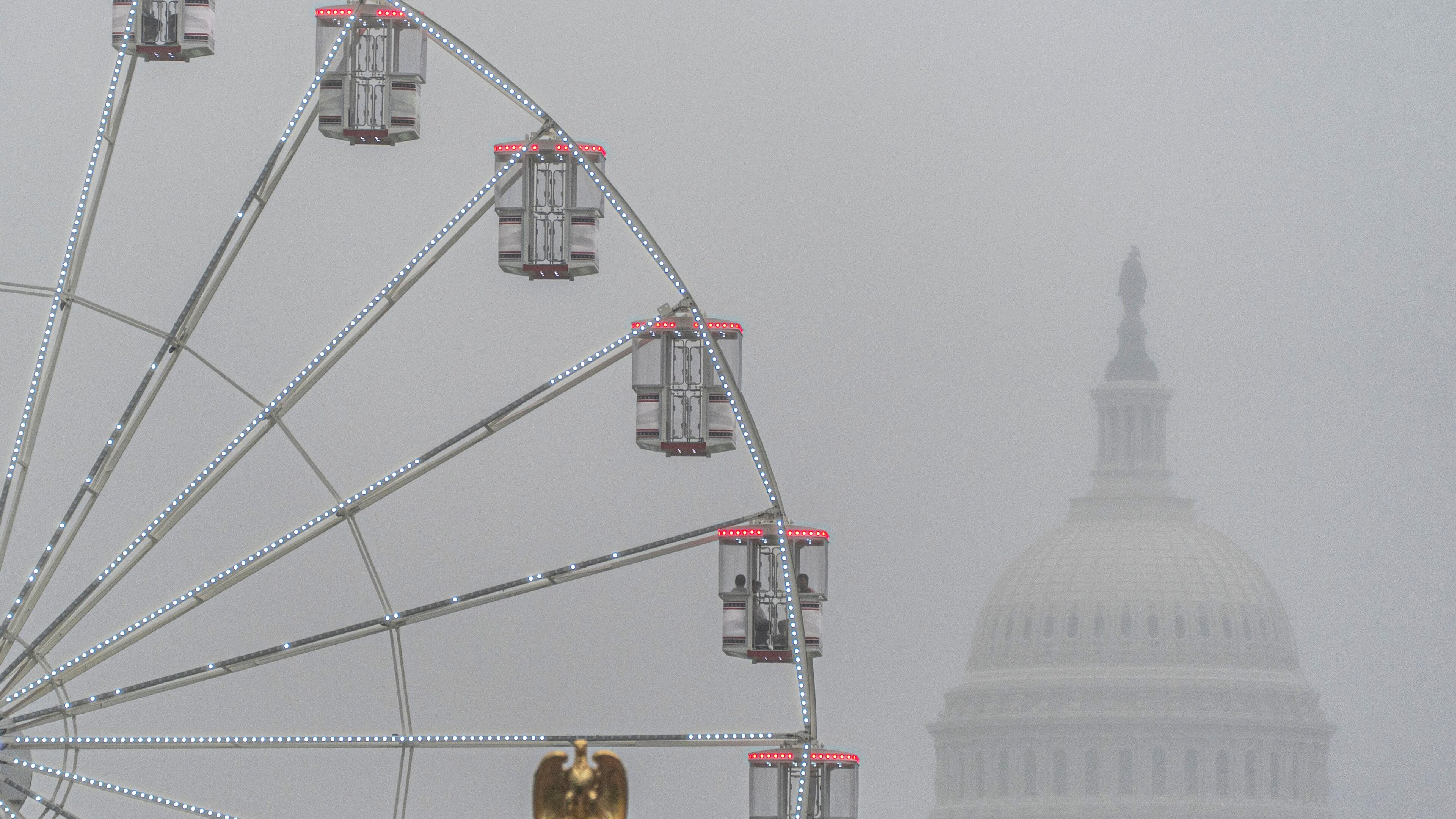 The U.S. Capitol is seen through fog behind the ferris wheel at the Great American State Fair on the National Mall, Sunday June 28, 2026, in Washington. (AP Photo/Jen Golbeck)