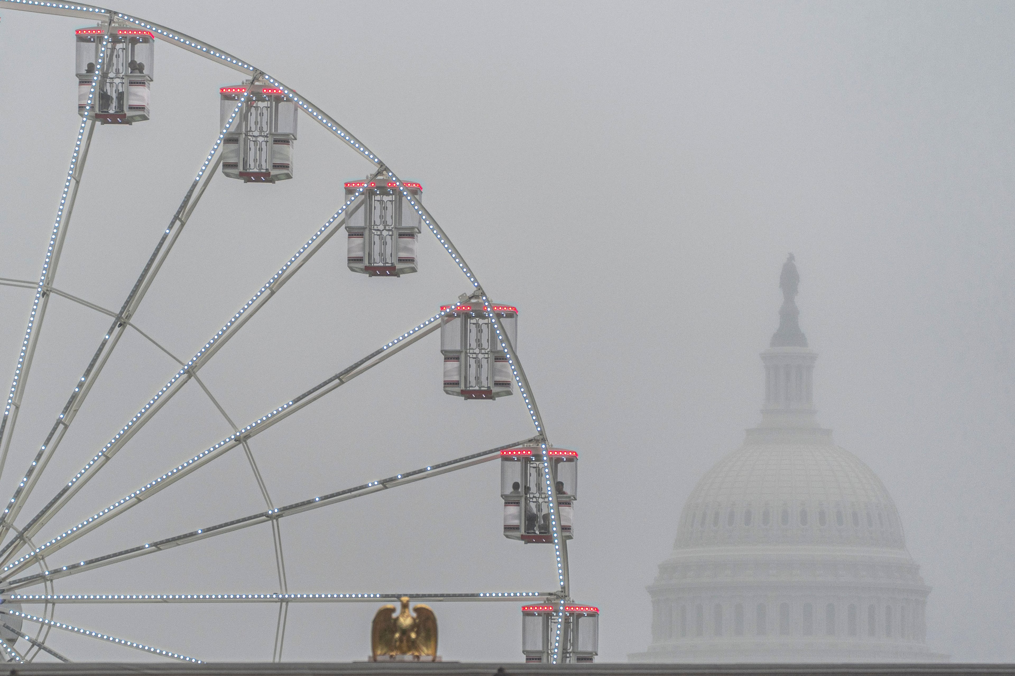 The U.S. Capitol is seen through fog behind the ferris wheel at the Great American State Fair on the National Mall last weekend in Washington, D.C. (Jen Golbeck/AP)