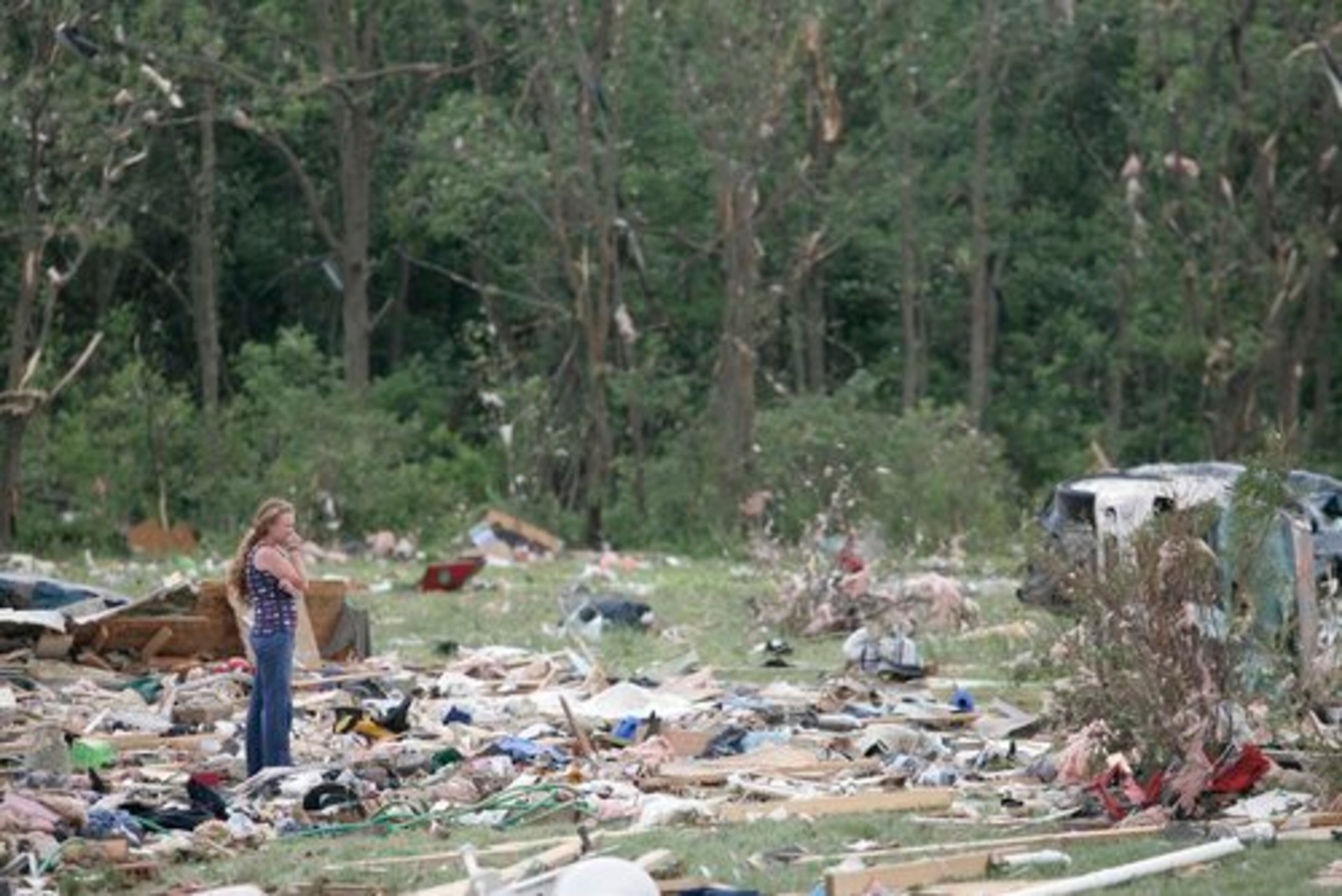 Kelly Kirchner looks over damage left by a tornado in Millbury, Ohio. Winds also damaged an Ohio high school gym where graduation was to be held Sunday.