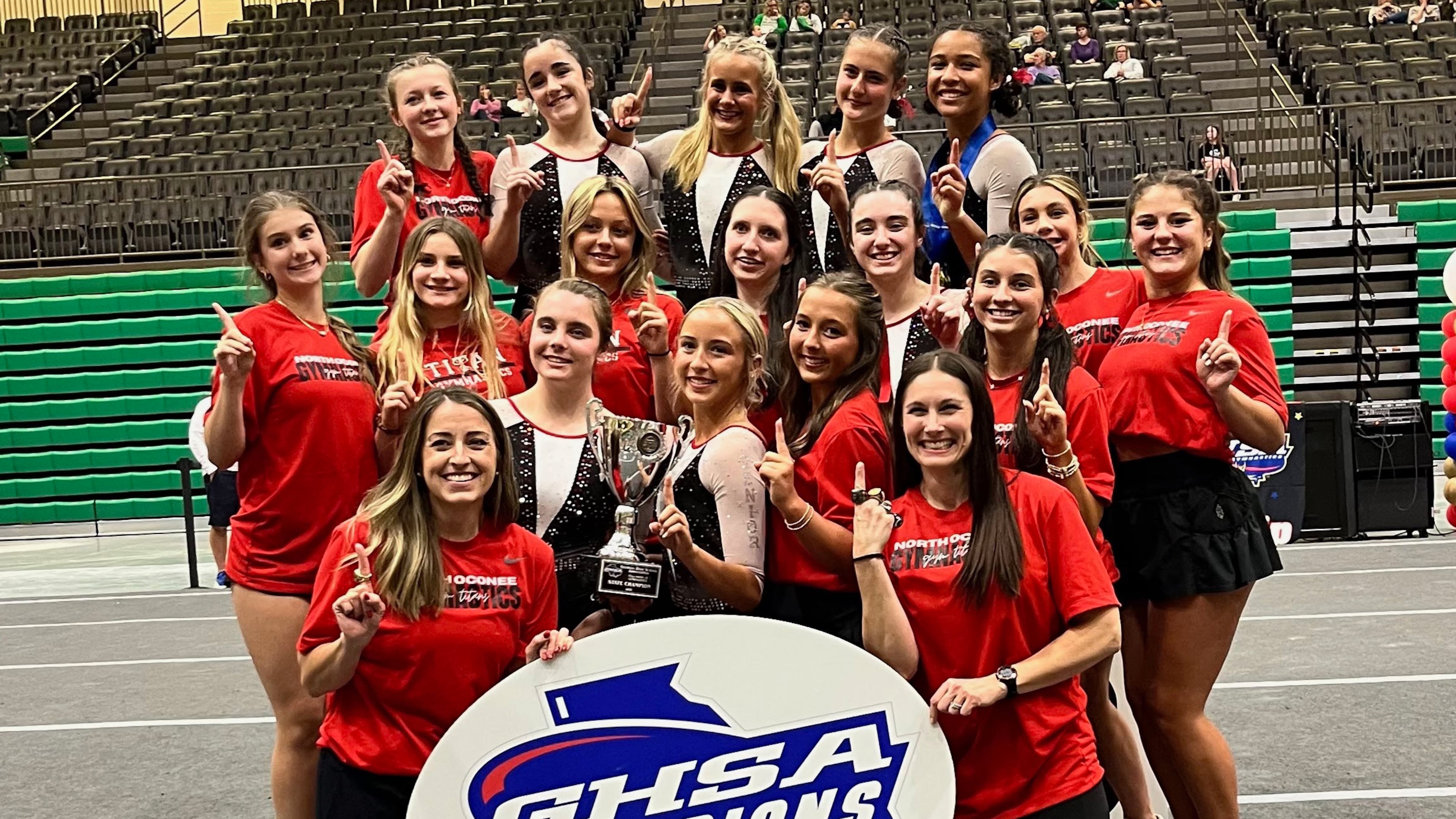 Coach Hillary Sanders (front left) poses with her team after North Oconee gymnastics won the GHSA 2025 Class A-4A state title. The Titans have won six consecutive state championship. (Photo courtesy of Hillary Sanders)