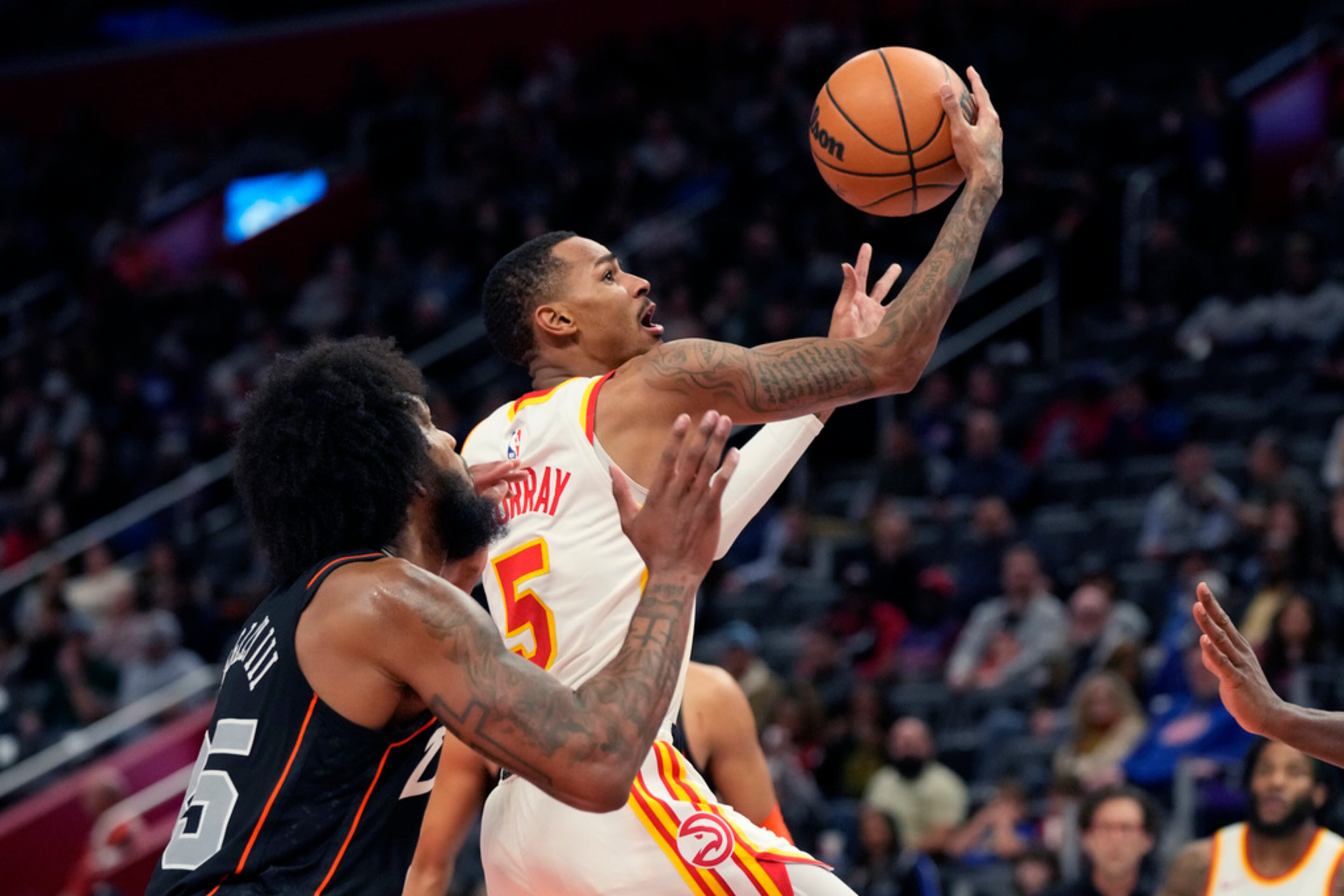 Atlanta Hawks guard Dejounte Murray (5) attempts a layup as Detroit Pistons forward Marvin Bagley III (35) defends during the first half of an NBA basketball game, Tuesday, Nov. 14, 2023, in Detroit. The Hawks won 126-120. (AP Photo/Carlos Osorio)