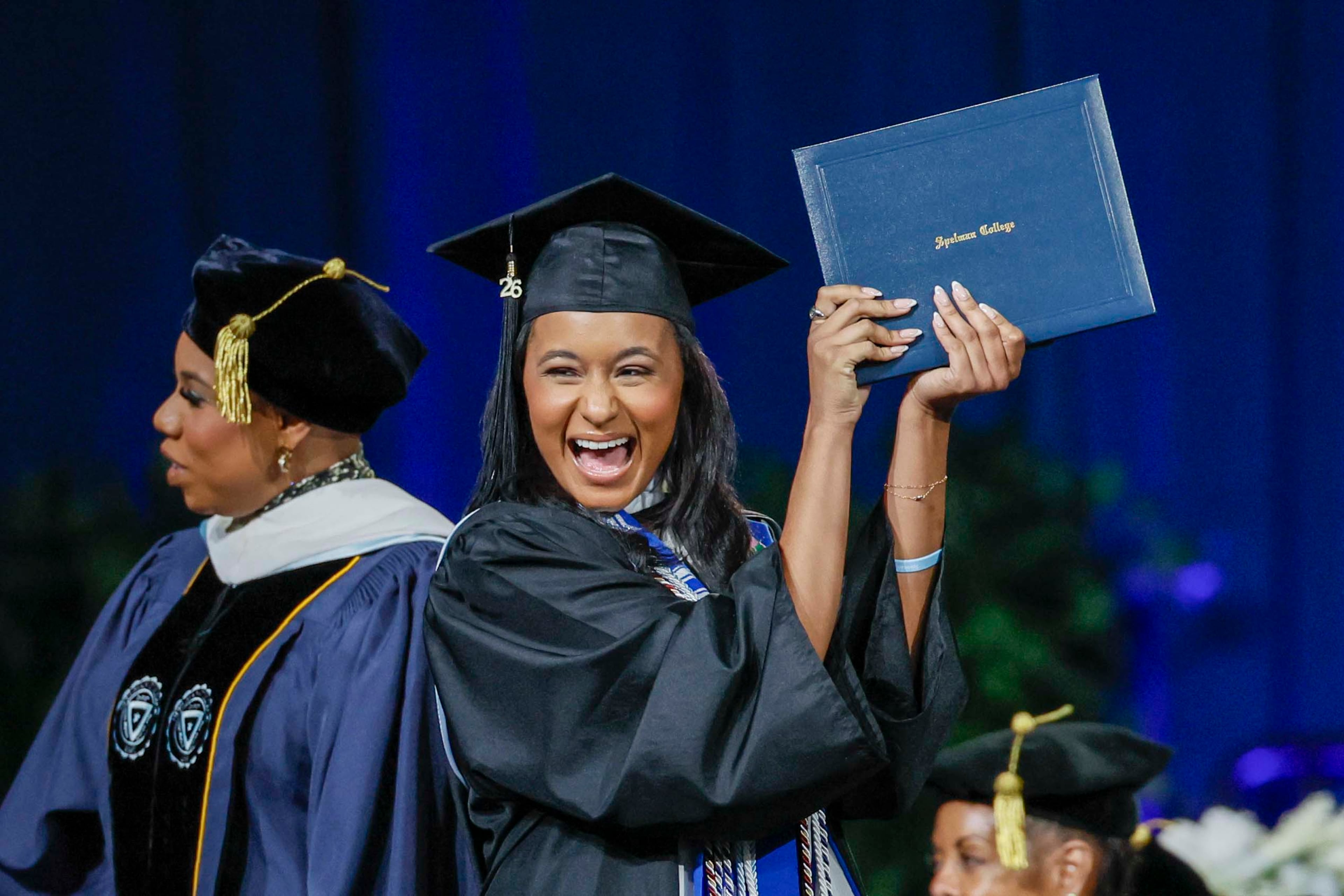 A graduate reacts after receiving her diploma during the Spelman College Commencement at the Georgia International Convention Center in College Park on Sunday, May 17, 2026. (Miguel Martinez/AJC)