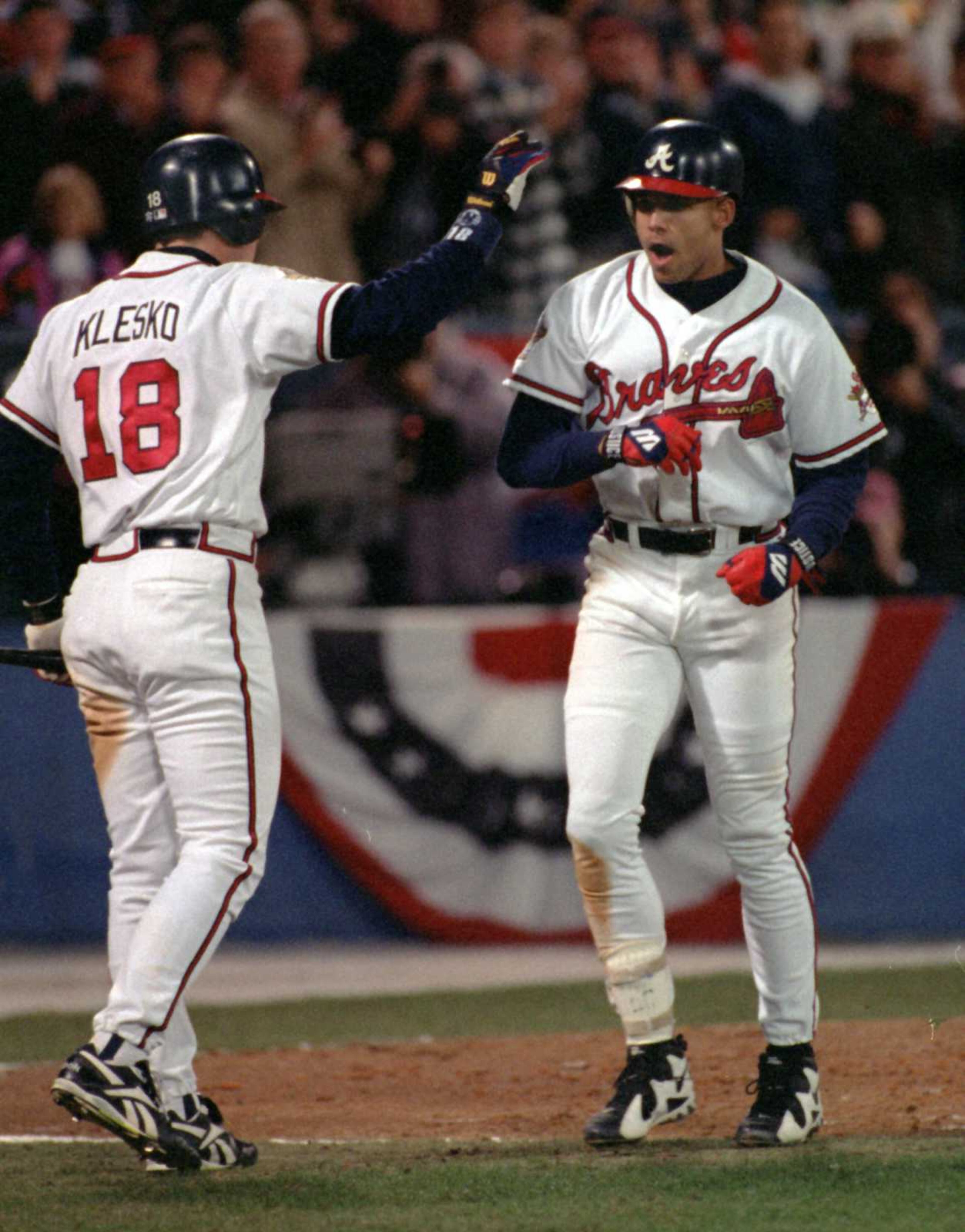 Ryan Klesko congratulates David Justice after Justice's homer in the 1995 World Series. (AJC photo/Frank Niemeir)