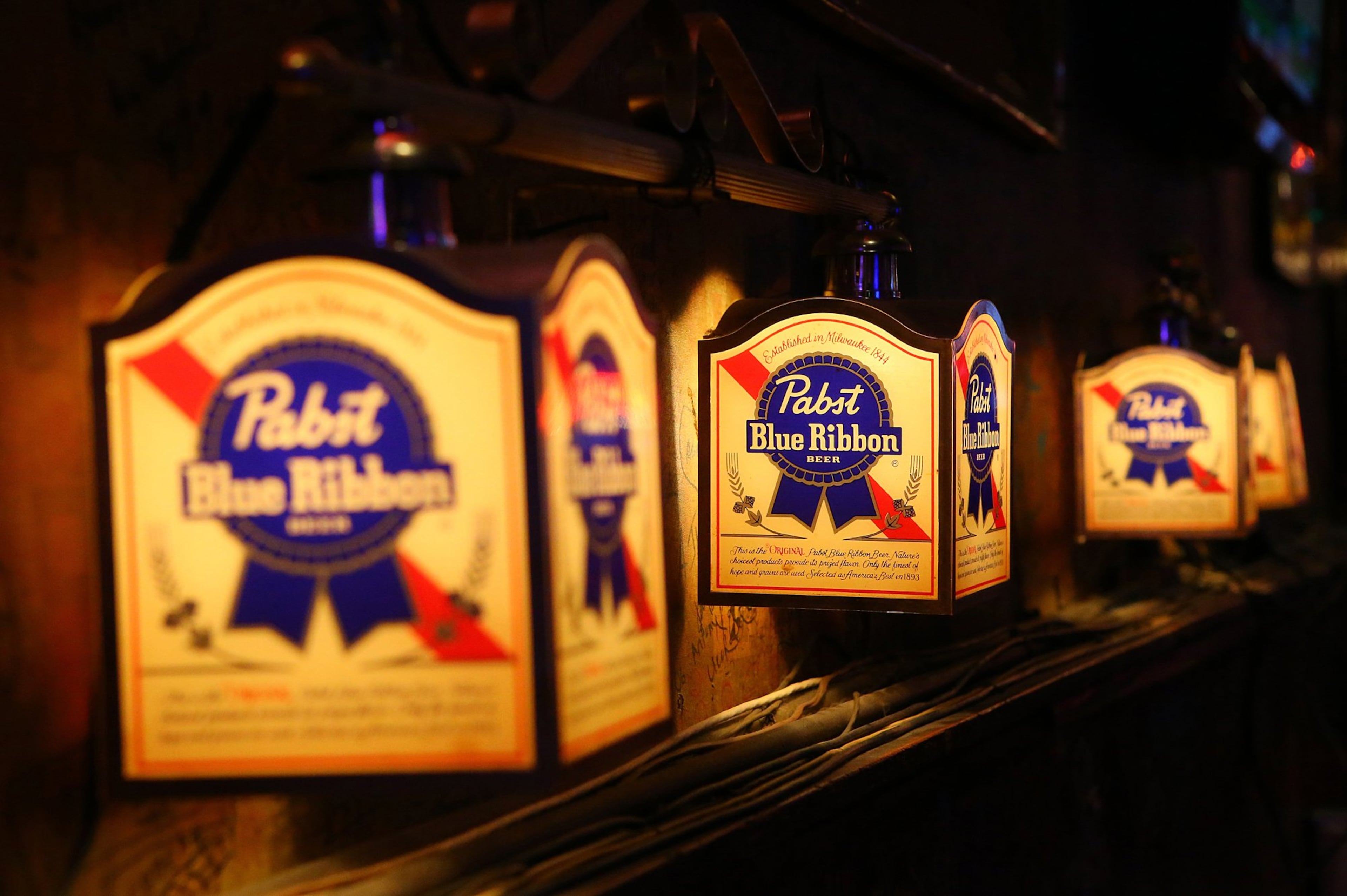Old Pabst Blue Ribbon Beer lights still hang on the wall over booths at Moe's & Joe's tavern on Tuesday, March 4, 2014, in Atlanta. CURTIS COMPTON / CCOMPTON@AJC.COM