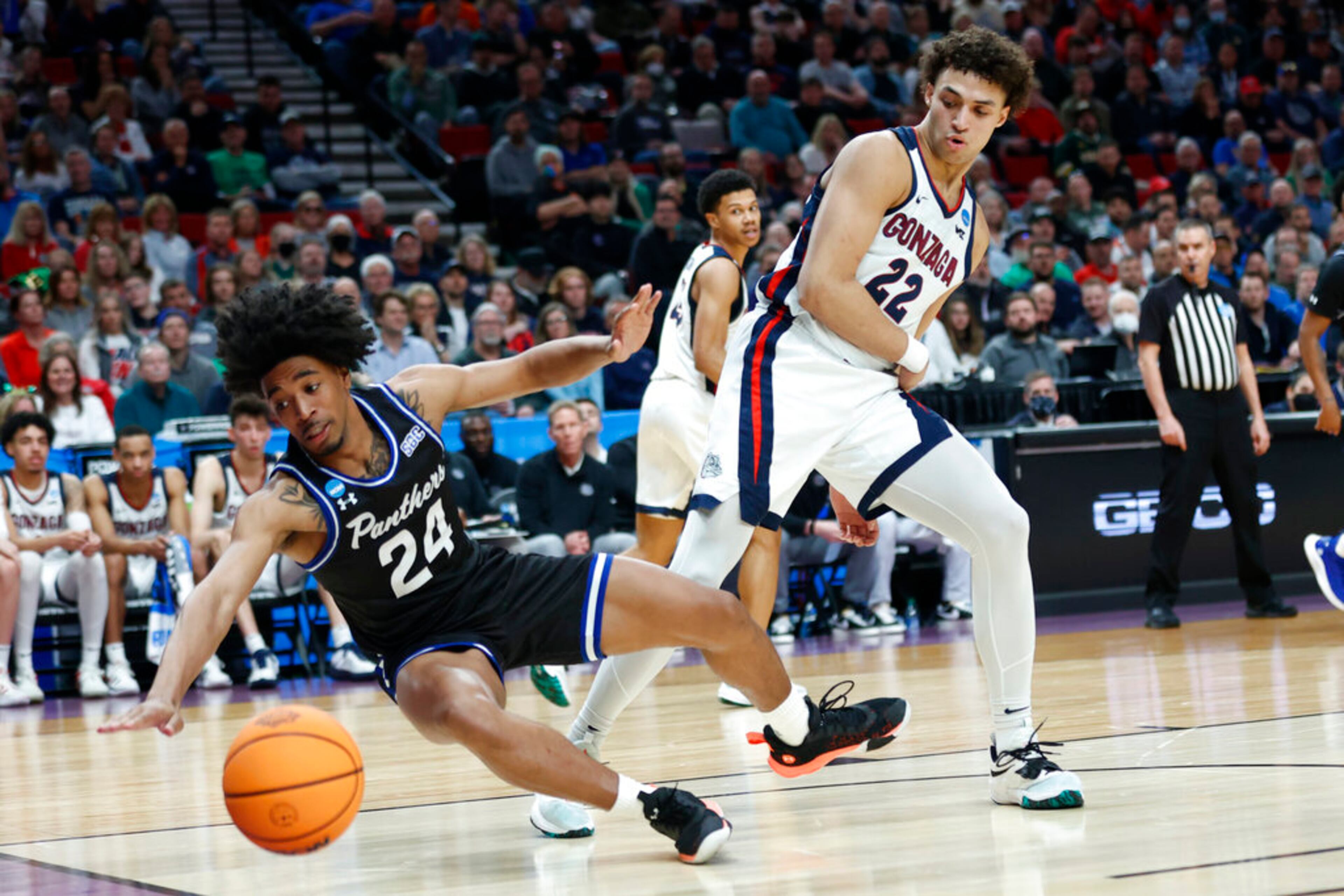Georgia State guard Collin Moore (24) goes down next to Gonzaga forward Anton Watson (22) during the first half of a first round NCAA college basketball tournament game, Thursday, March 17, 2022, in Portland, Ore. (AP Photo/Craig Mitchelldyer)