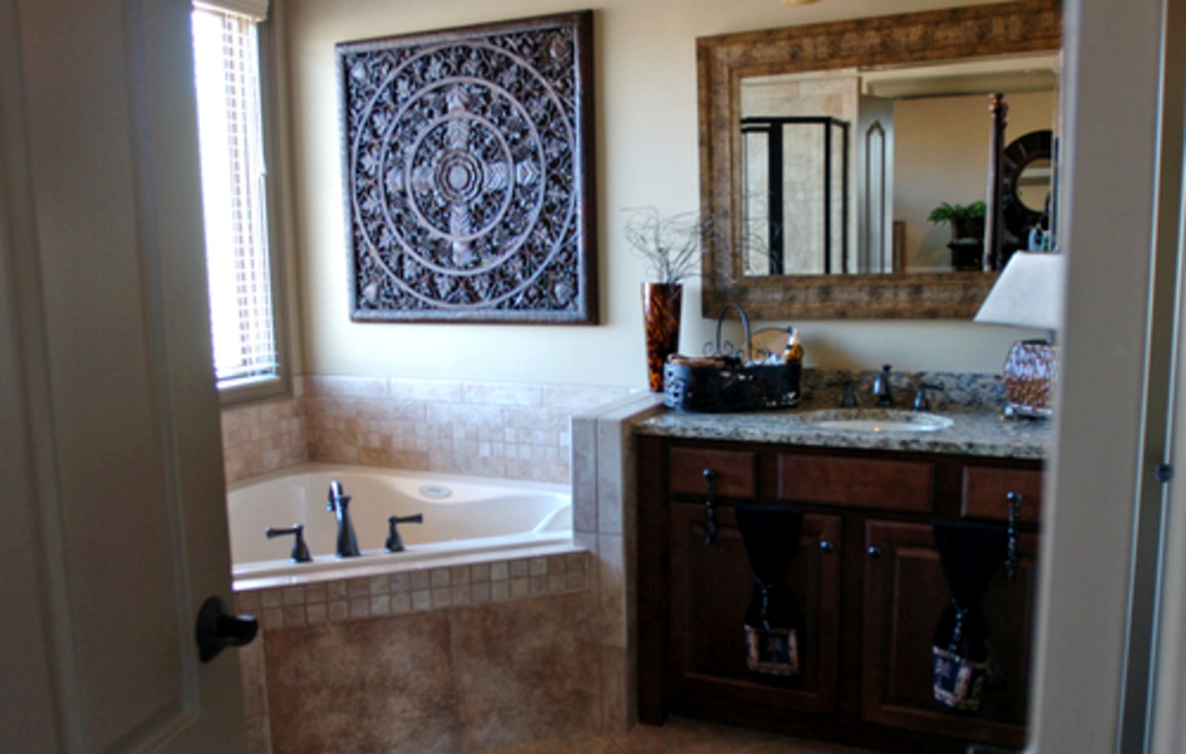 Guests are treated well at the Beardslees' home. The guest bath includes a Jacuzzi tub and separate shower. Lori Beardslee hung a wooden wall hanging above the tub to give the room visual interest. It looks like an antique from Bali, but Beardslee said it probably came from a home decor store.