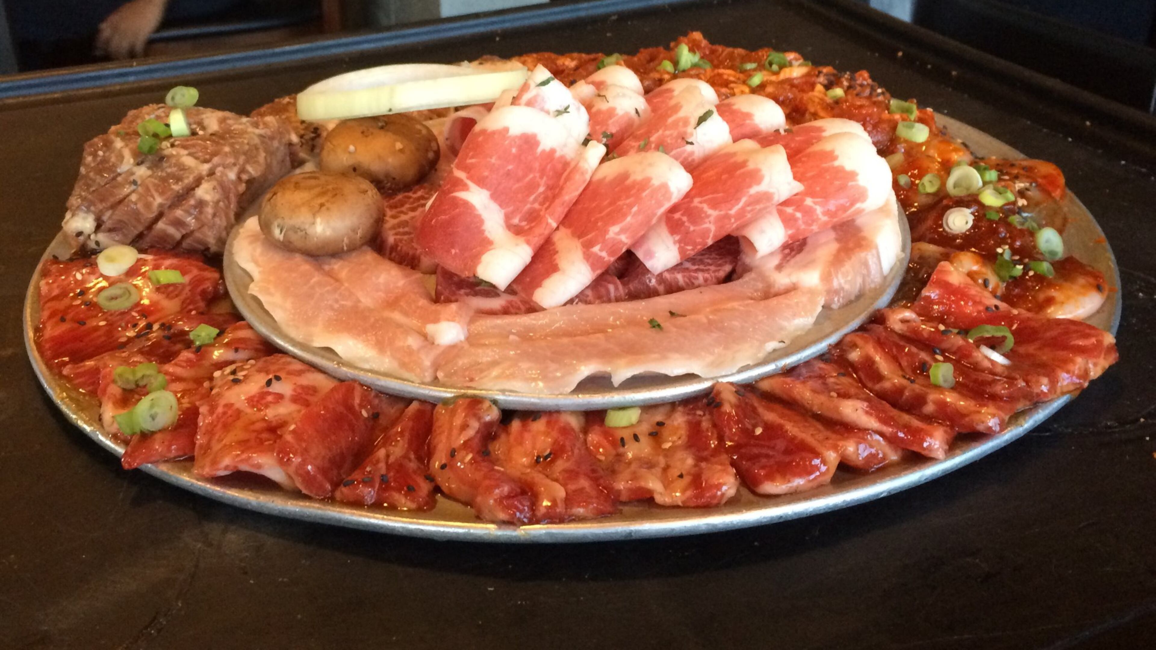 The beef and pork combo at K-BBQ Factory in Duluth arrives at the table looking like a deli platter of raw meat. CONTRIBUTED BY WENDELL BROCK