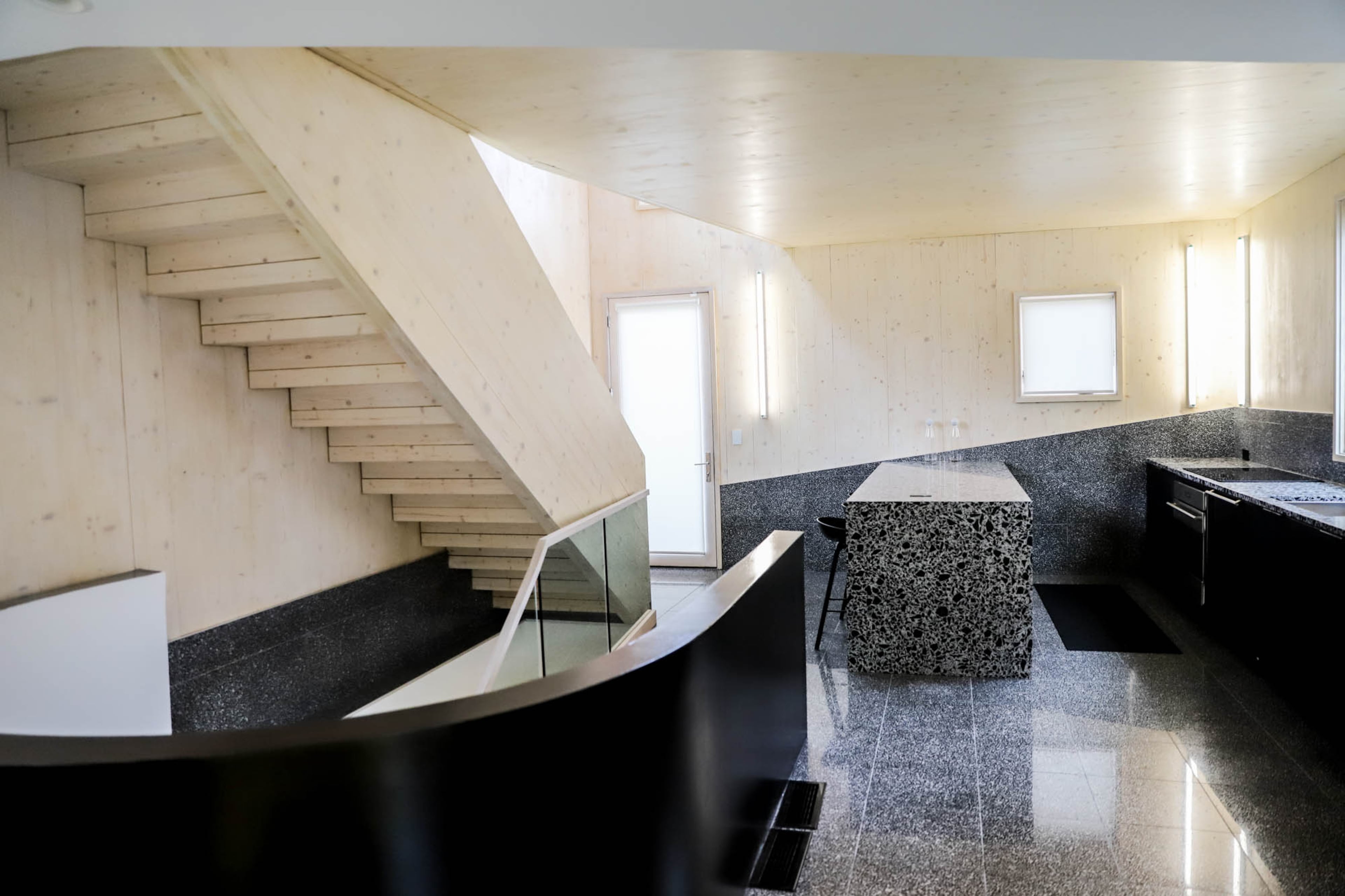 The home in Atlanta's Old Fourth Ward has a width of nearly 18 feet. The floor tile and part of the walls use terrazzo by Eco-Terr, while the rest of the walls, ceiling and staircase are a showcase for cross-laminated timber.