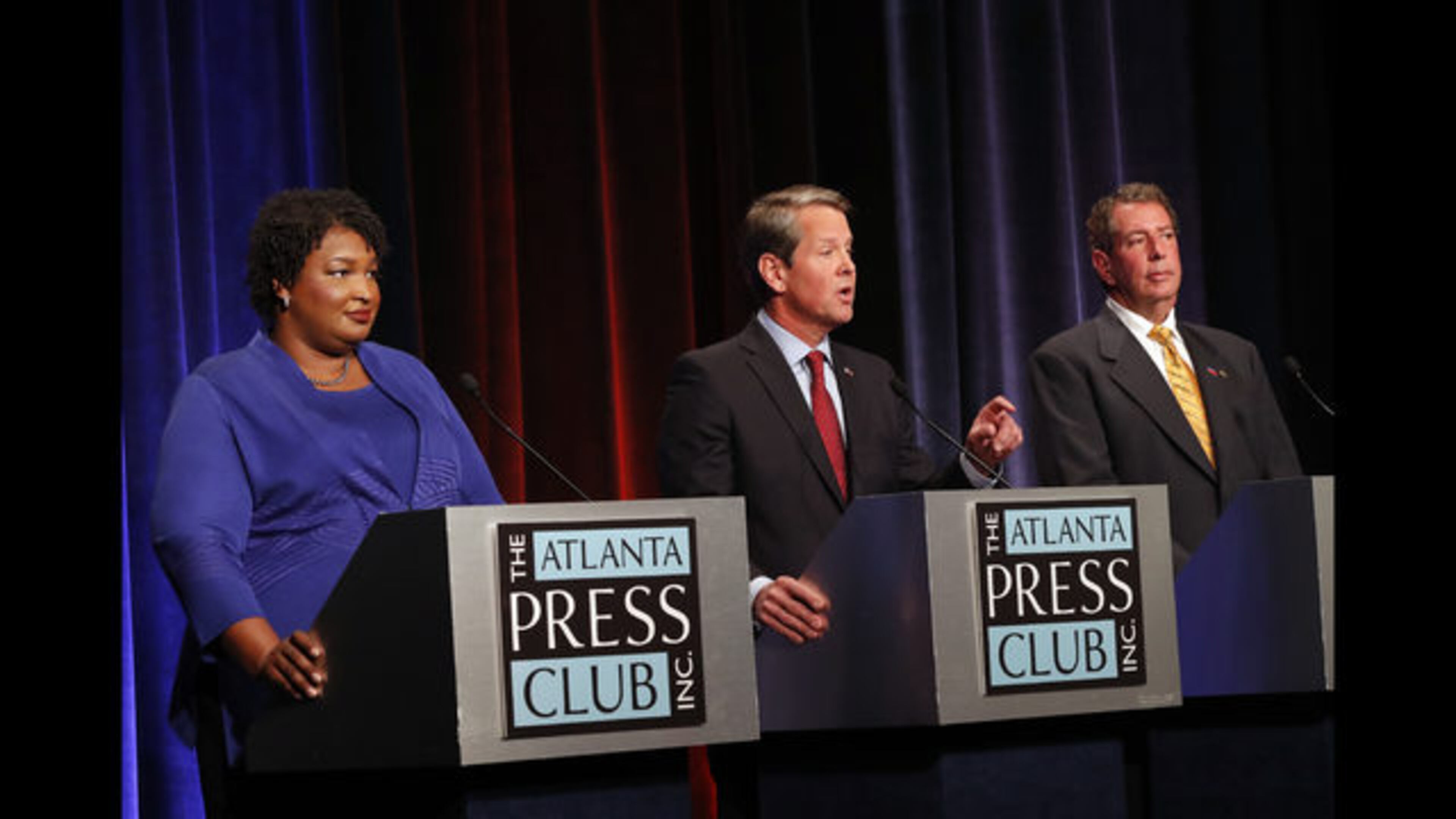 Democrat Stacey Abrams (from left), Republican Brian Kemp an Libertarian Ted Metz take part in a gubernatorial debate Tuesday, Oct. 23, 2018, in Atlanta. (AP Photo/John Bazemore)