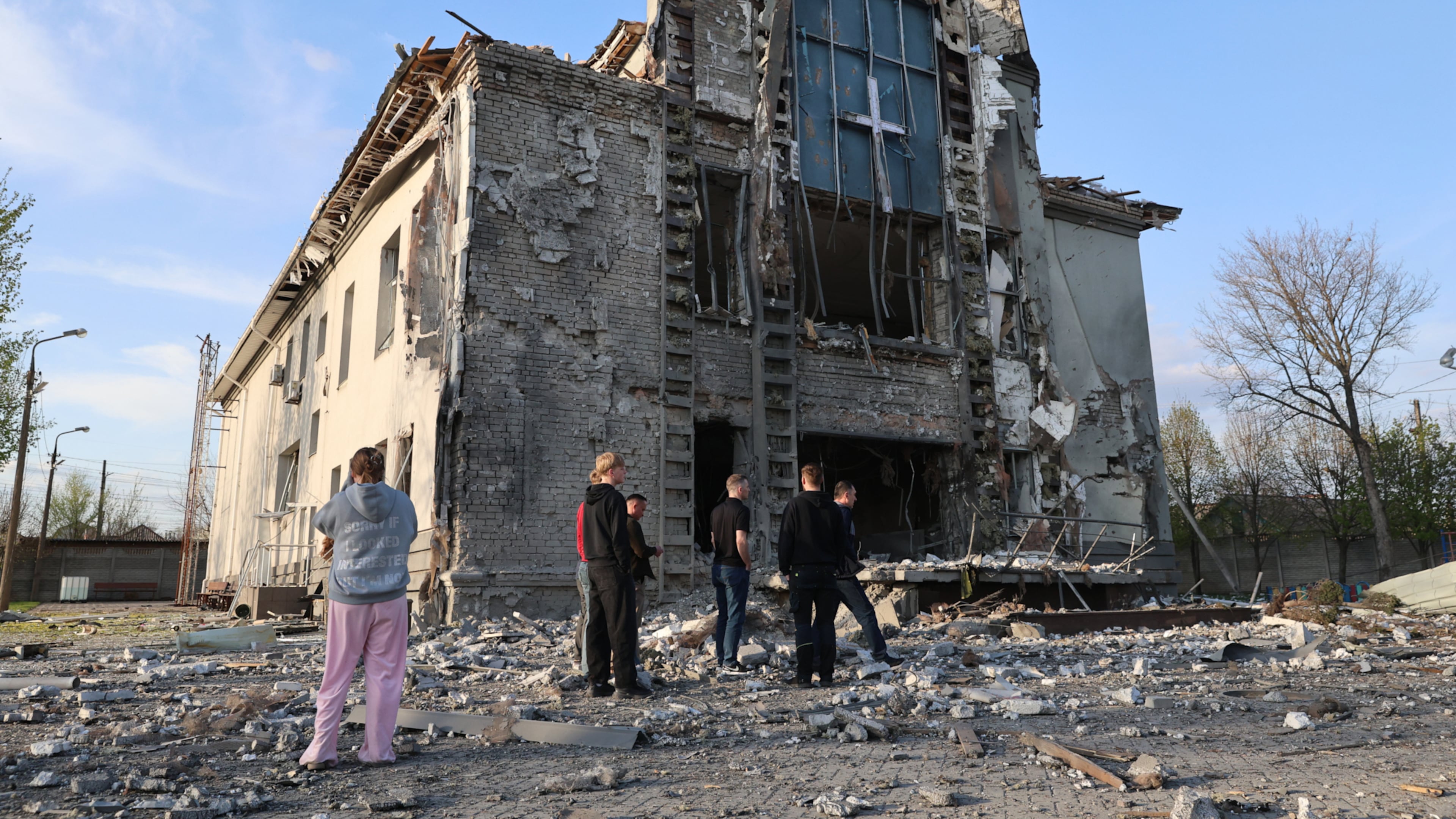 People stand outside a Baptist church damaged by a Russian guided aerial bomb, in Zaporizhzhia, Ukraine, Thursday, April 16, 2026. (AP Photo/Kateryna Klochko)