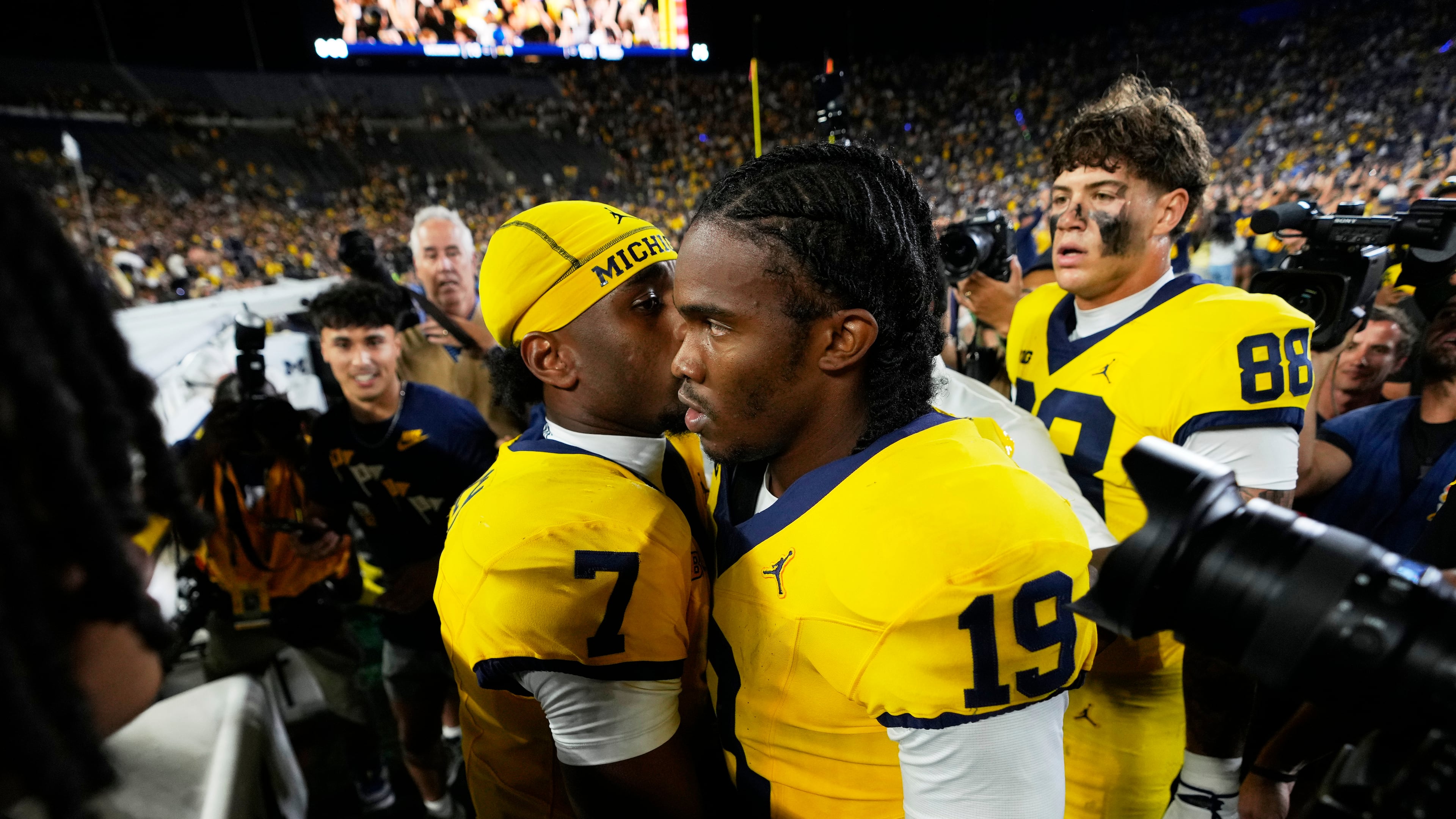 Michigan quarterback Bryce Underwood (19) talks with Chris Bracy (7) after an NCAA college football game against the Western Michigan Saturday, Sept. 5, 2026, in Ann Arbor, Mich. (AP Photo/Paul Sancya)