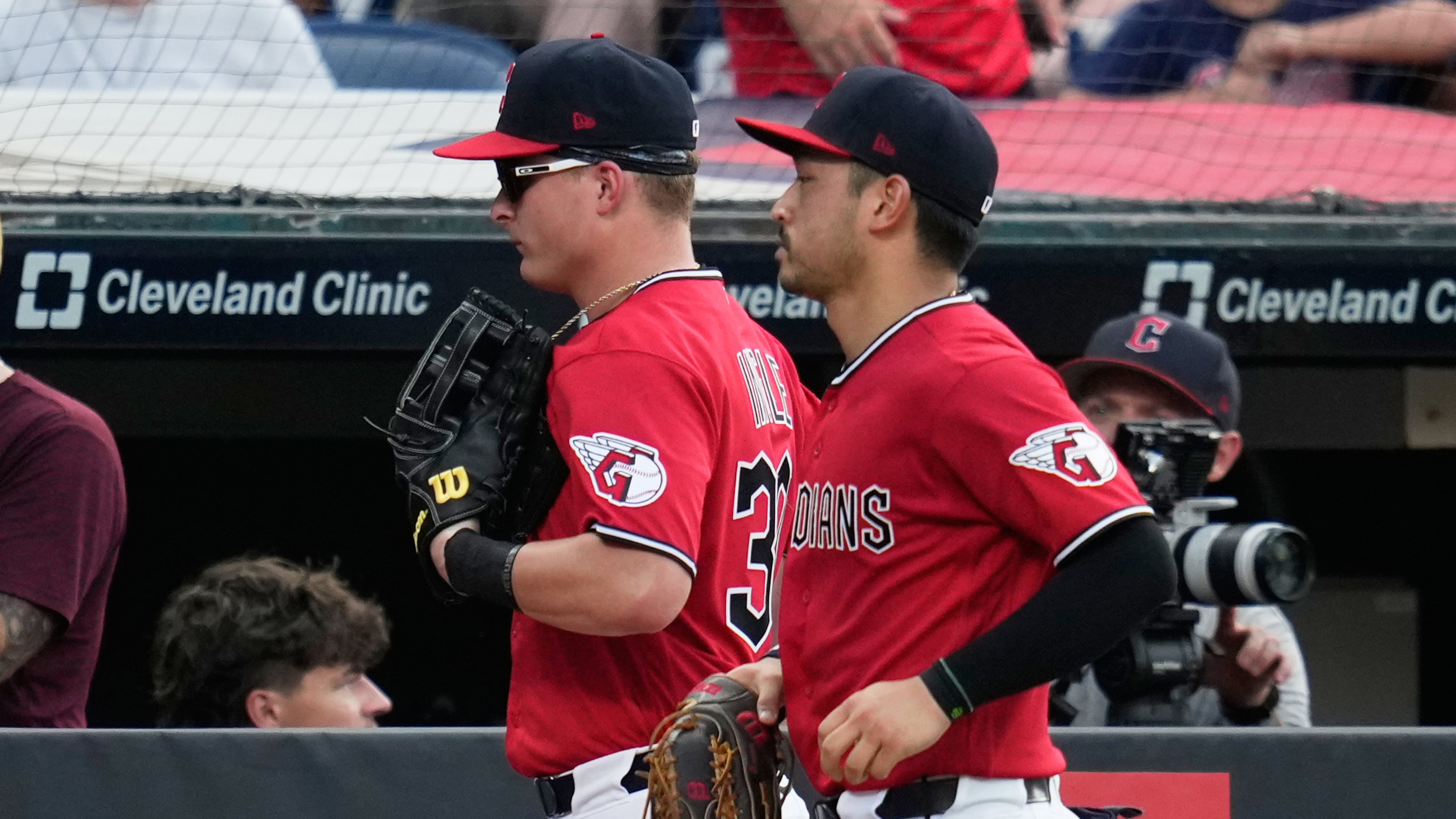 Cleveland Guardians left fielder Cooper Ingle, left, runs in from the outfield with center fielder Steven Kwan, right, after the first half of the seventh inning of a baseball game against the Texas Rangers in Cleveland, Tuesday, June 30, 2026. (AP Photo/Sue Ogrocki)