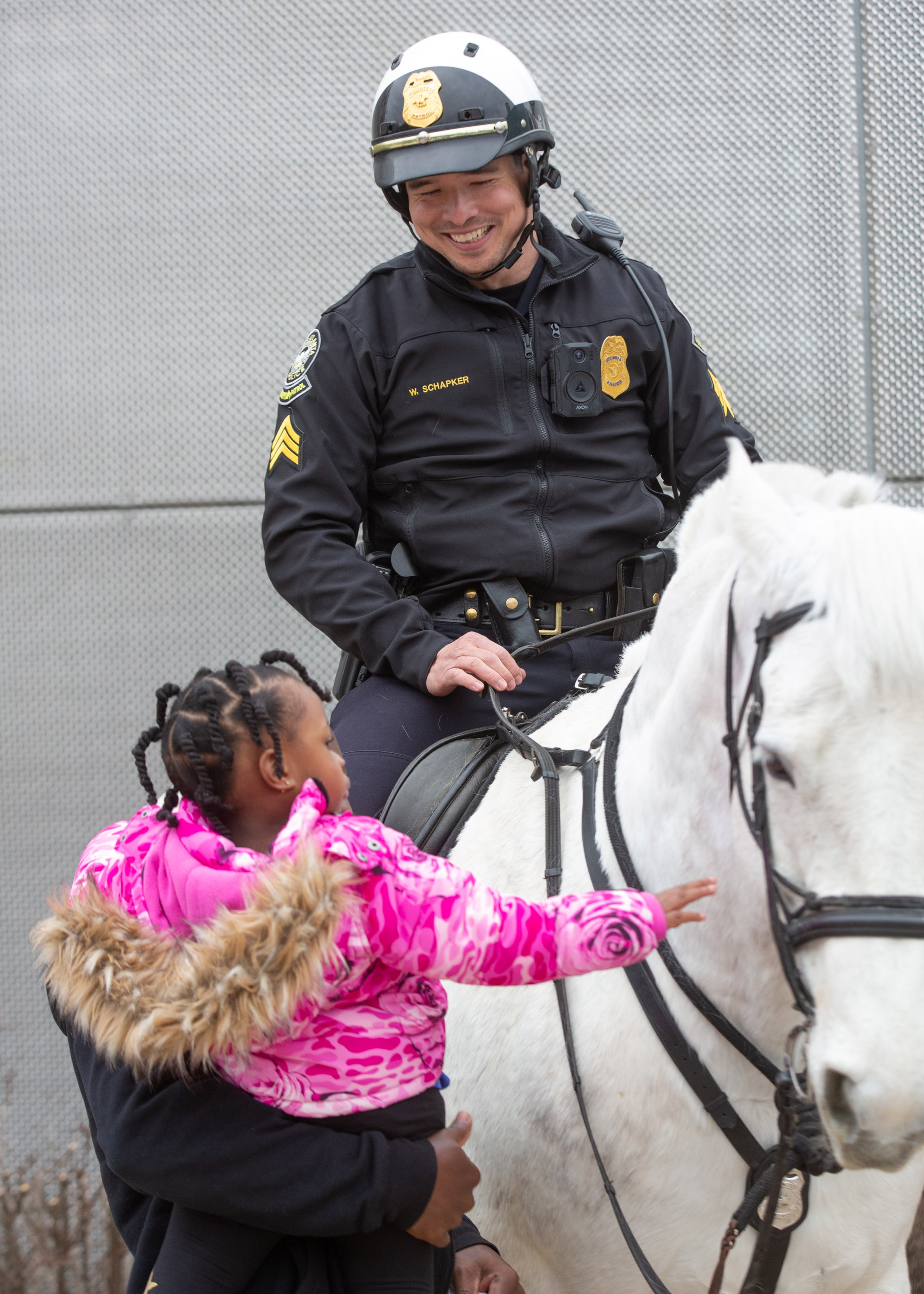 Sgt. Will Schapker talks with people as they walk by as the Atlanta Police Mounted Patrol works near the Georgia Aquarium on Saturday, March 6, 2021. (Photo: Steve Schaefer for The Atlanta Journal-Constitution)